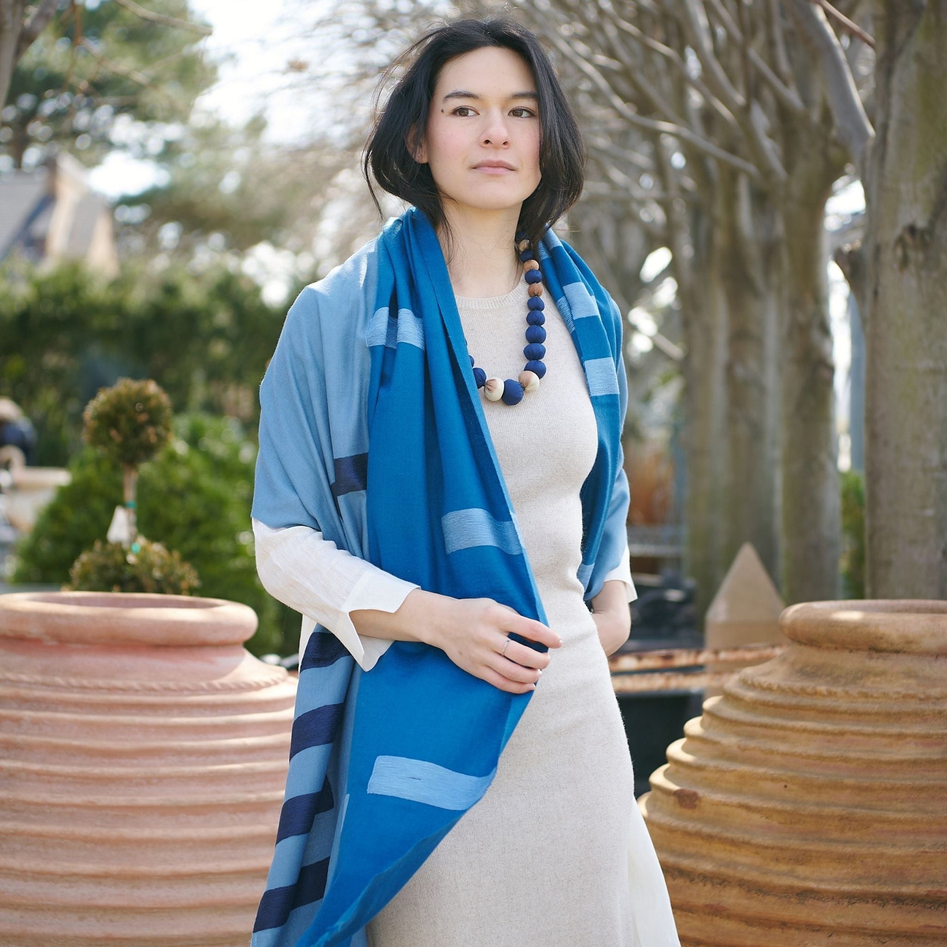 Harbor Blue Silk Merino Hand Woven Hand Embroidered Modern Artisanal Scarf worn by a model outdoors.