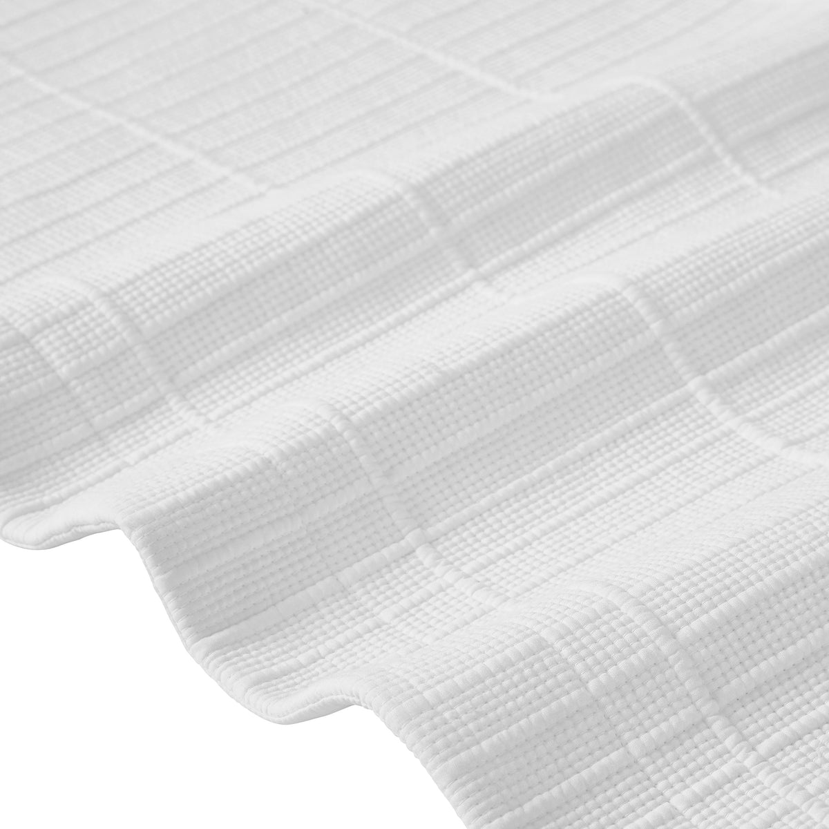 CL-268-11096_9|Close-up of a luxurious white textured coverlet, highlighting its intricate woven pattern and soft, inviting feel.