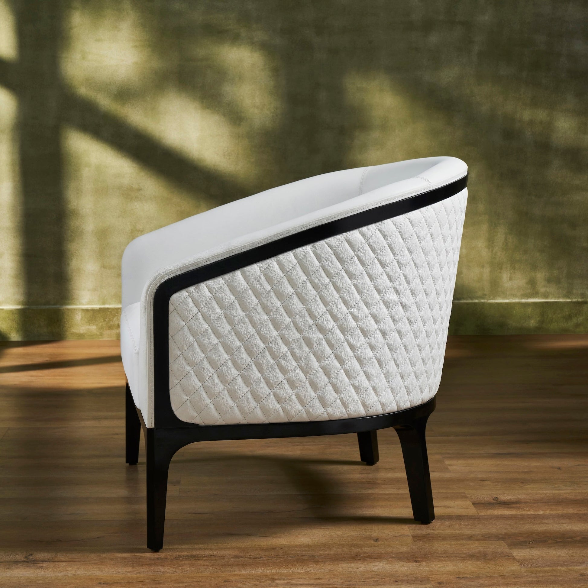 FN-5204-343329_3|Back view of a white leather armchair with quilted side panel and dark wood frame, modern luxury leather furniture.