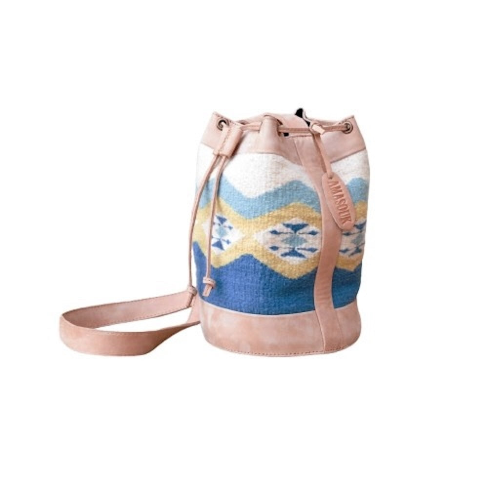 Colibrí Cinched Bucket Bag in handwoven wool and leather with green and blue Zapotec diamond and butterfly pattern, featuring an adjustable strap and cinched silhouette.