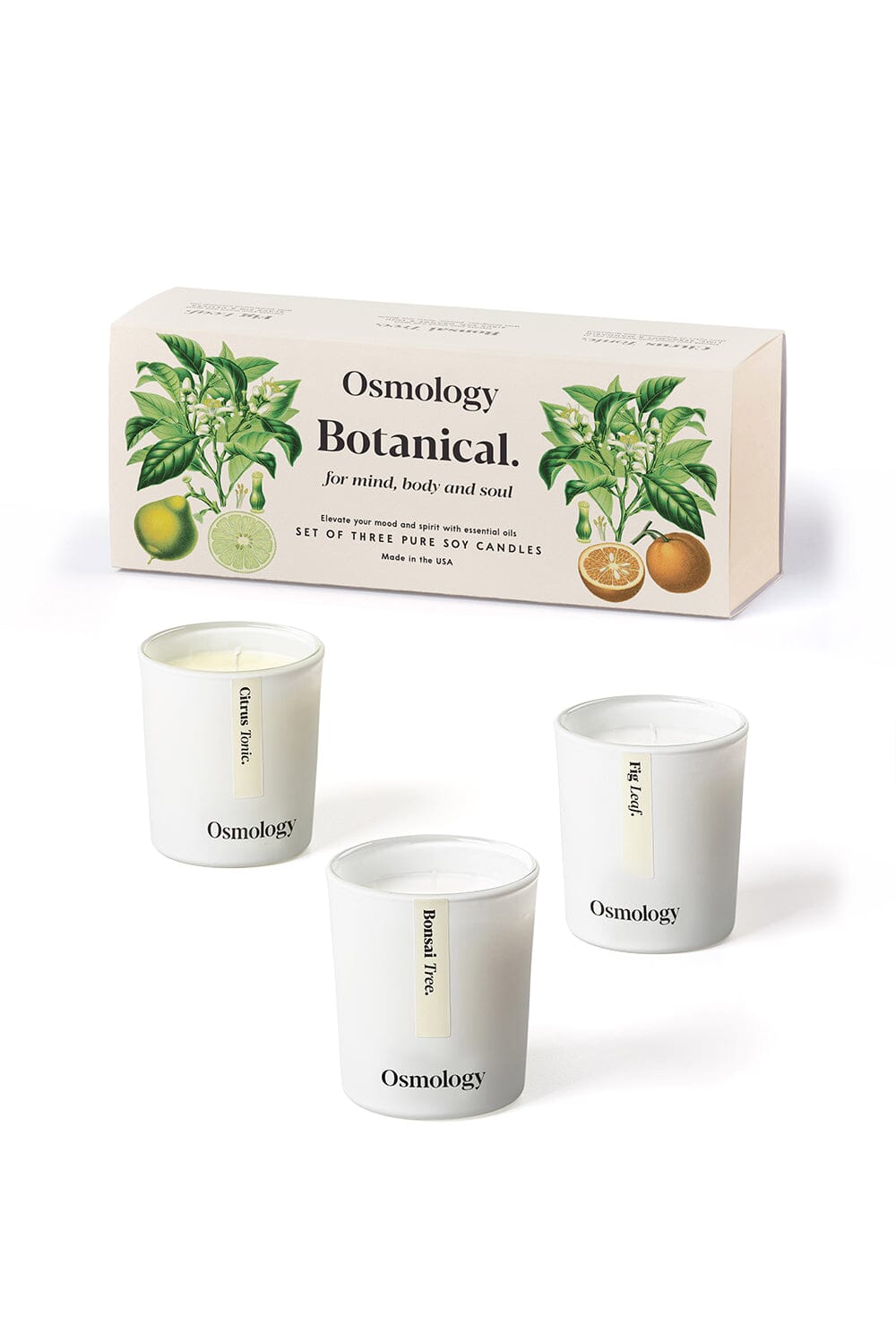 Osmology Botanical gift set of mini candles displayed next to product packaging against an orange-cream background