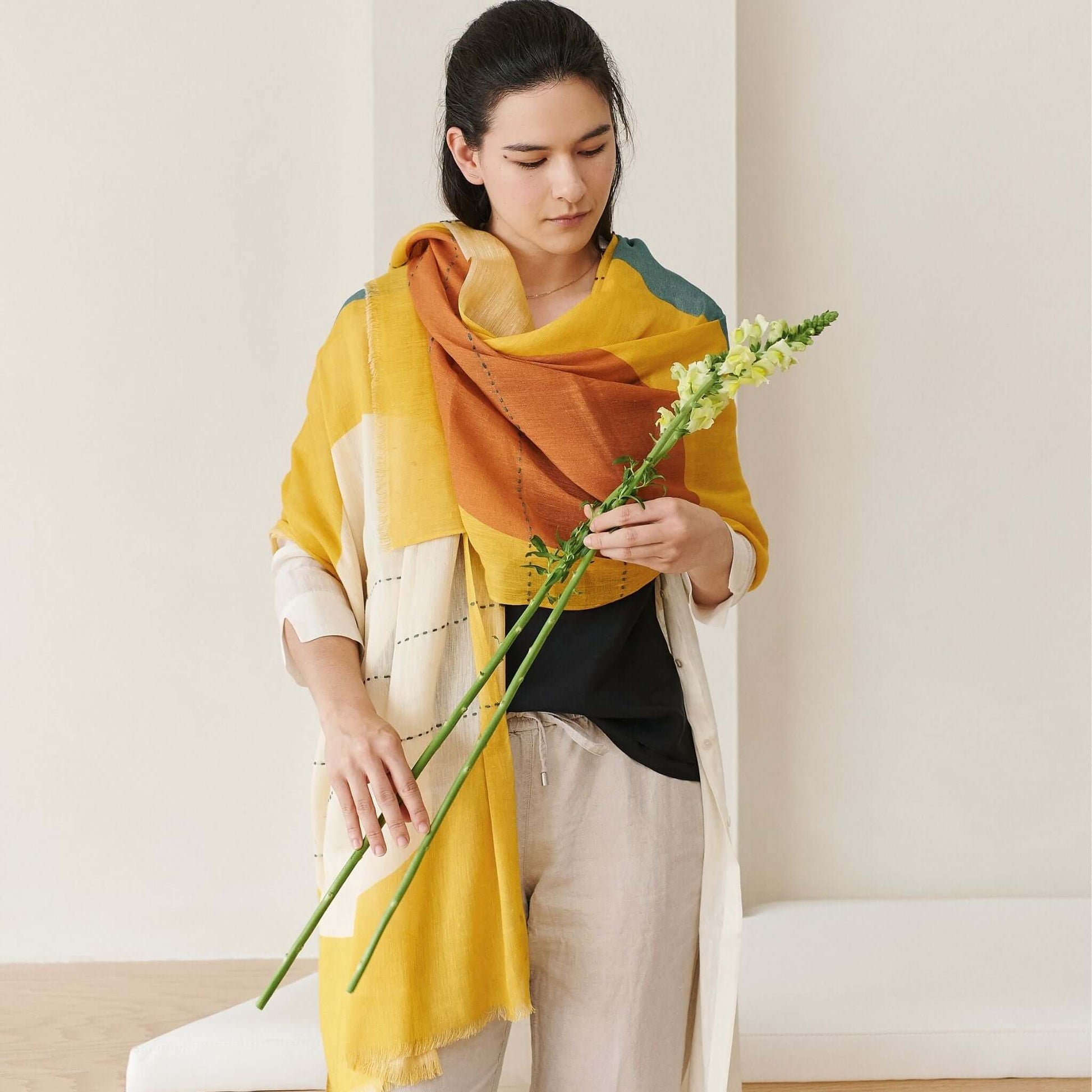Cirq Sun Yellow Green Circle Pattern Hand Embroidered  Linen Silk Handloom Scarf worn with a flower.