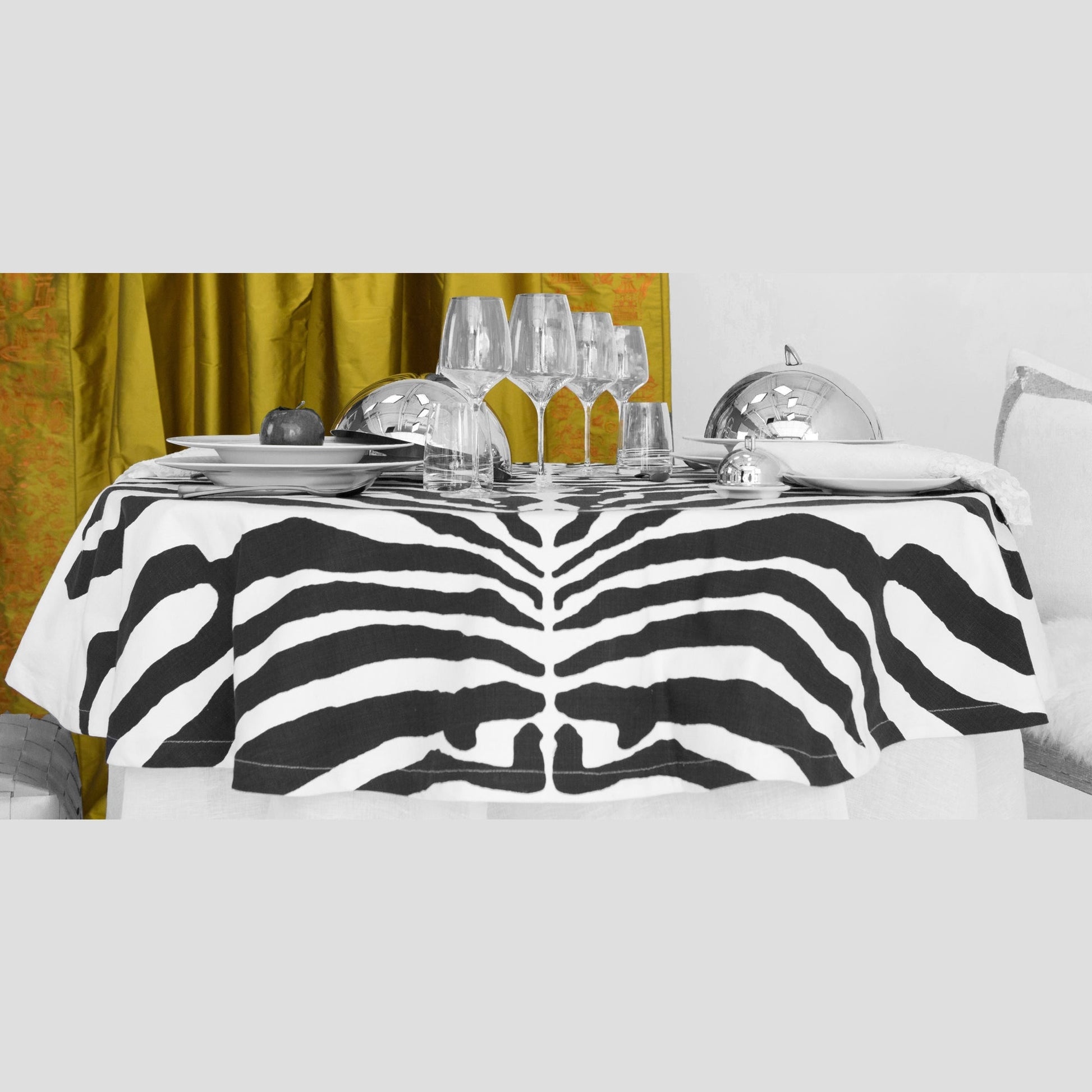 TC-4501B-6090_2|Elegant black and white zebra print tablecloth draped over a dining table, creating a luxurious and exotic tablescape setting.