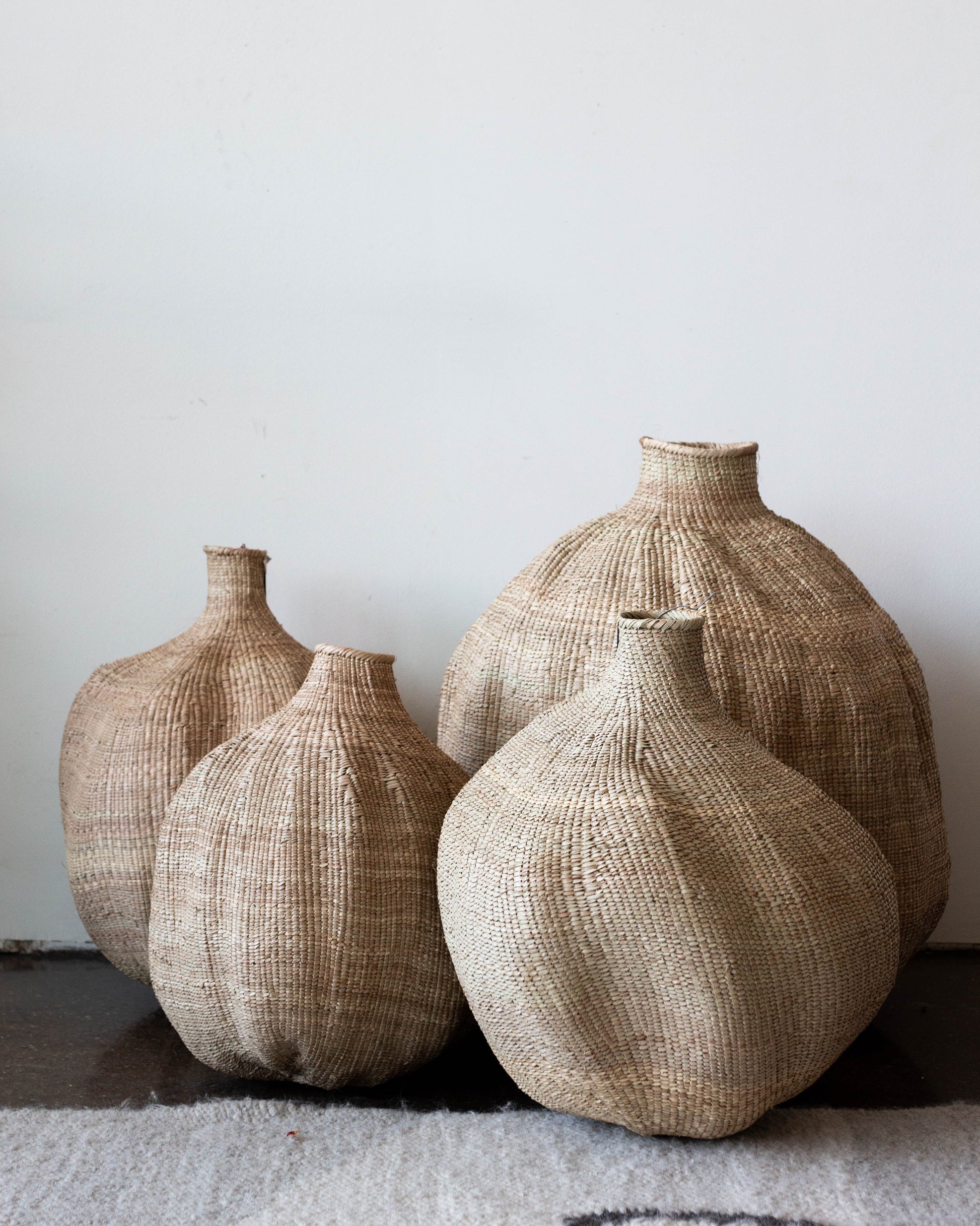 assorted woven african baskets placed in a group on the floor