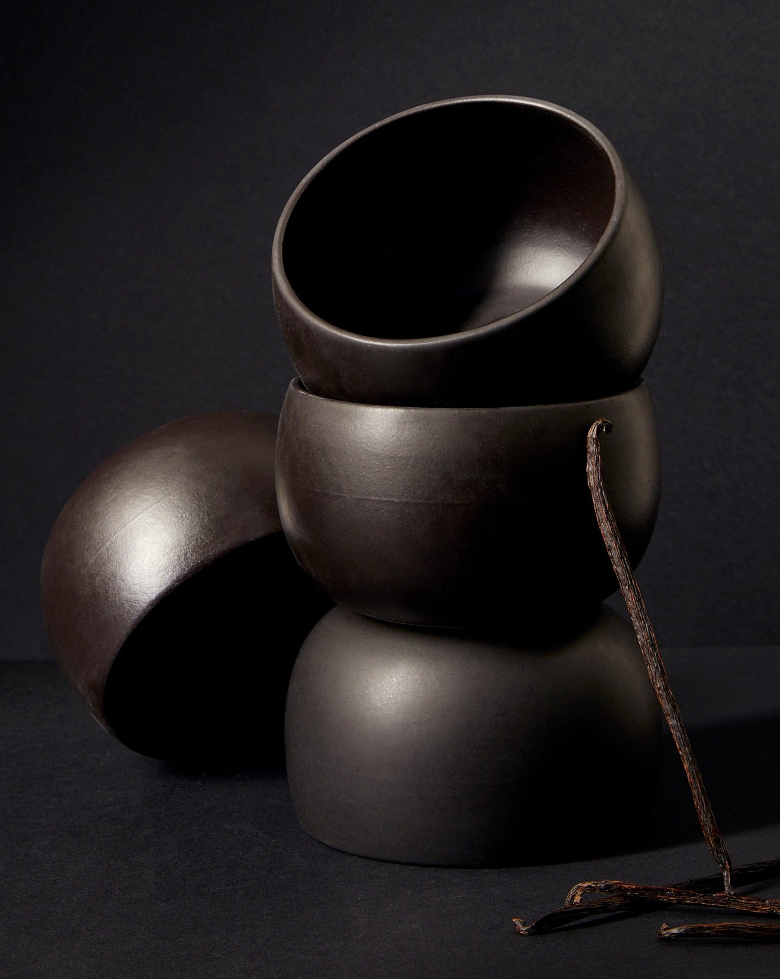 A stack of three white stoneware soup bowls of different sizes on a neutral background.