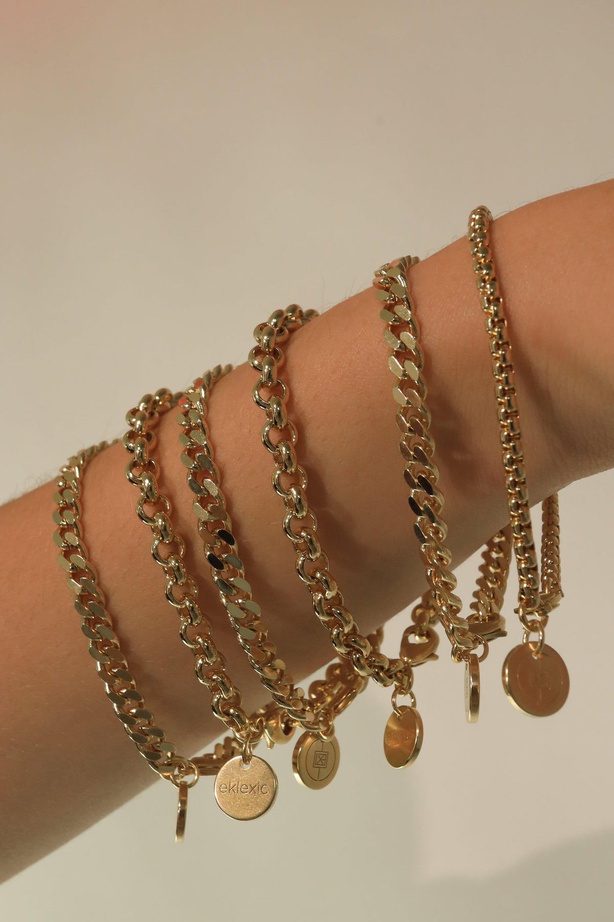 Gold chain bracelets with pendants displayed on Thin Luciana Bracelet product