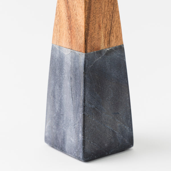 close-up of black marble and wood contrast on candleholder