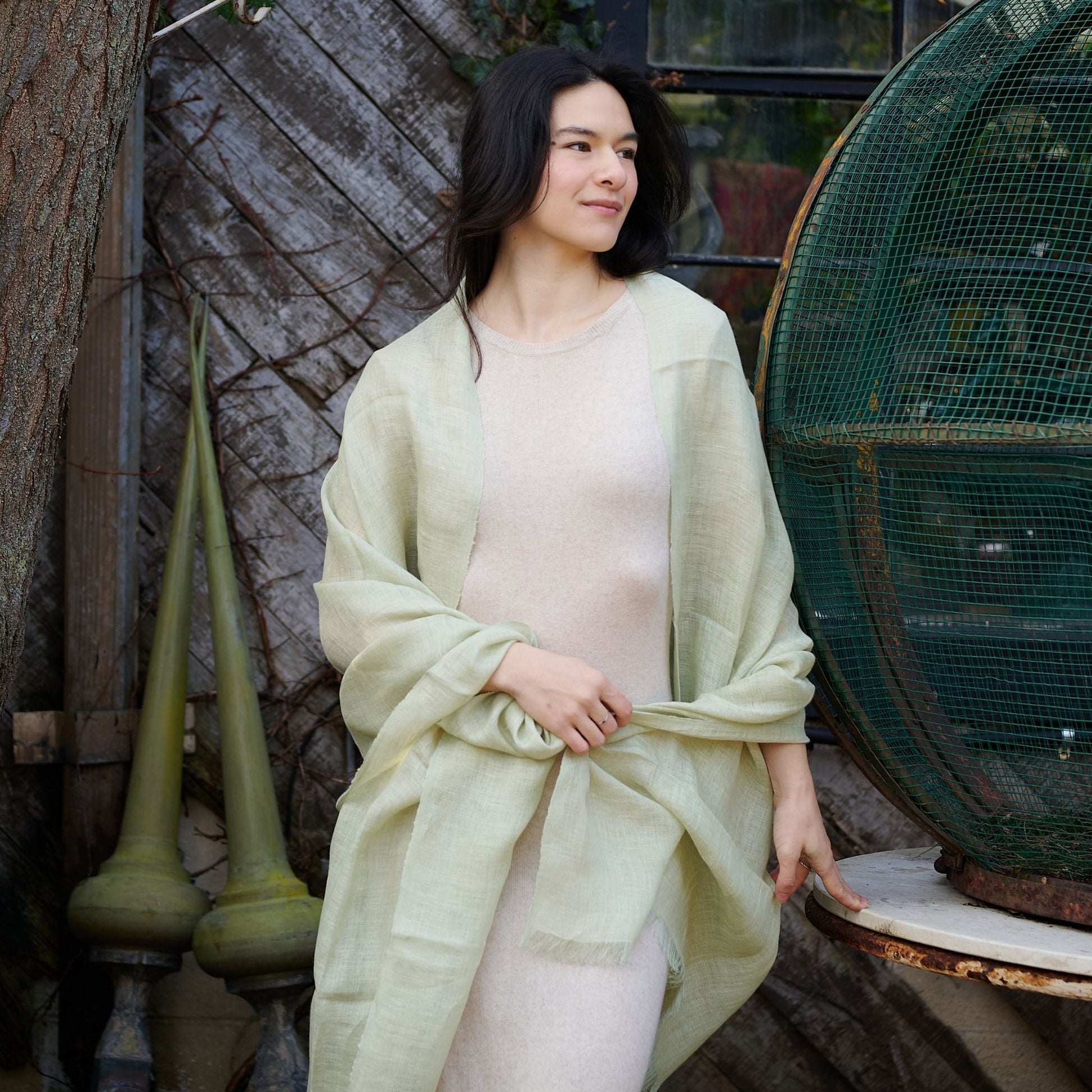 Soya Pastel Lime Green Hand Woven Soft Linen Scarf worn elegantly over a light dress against a rustic background.