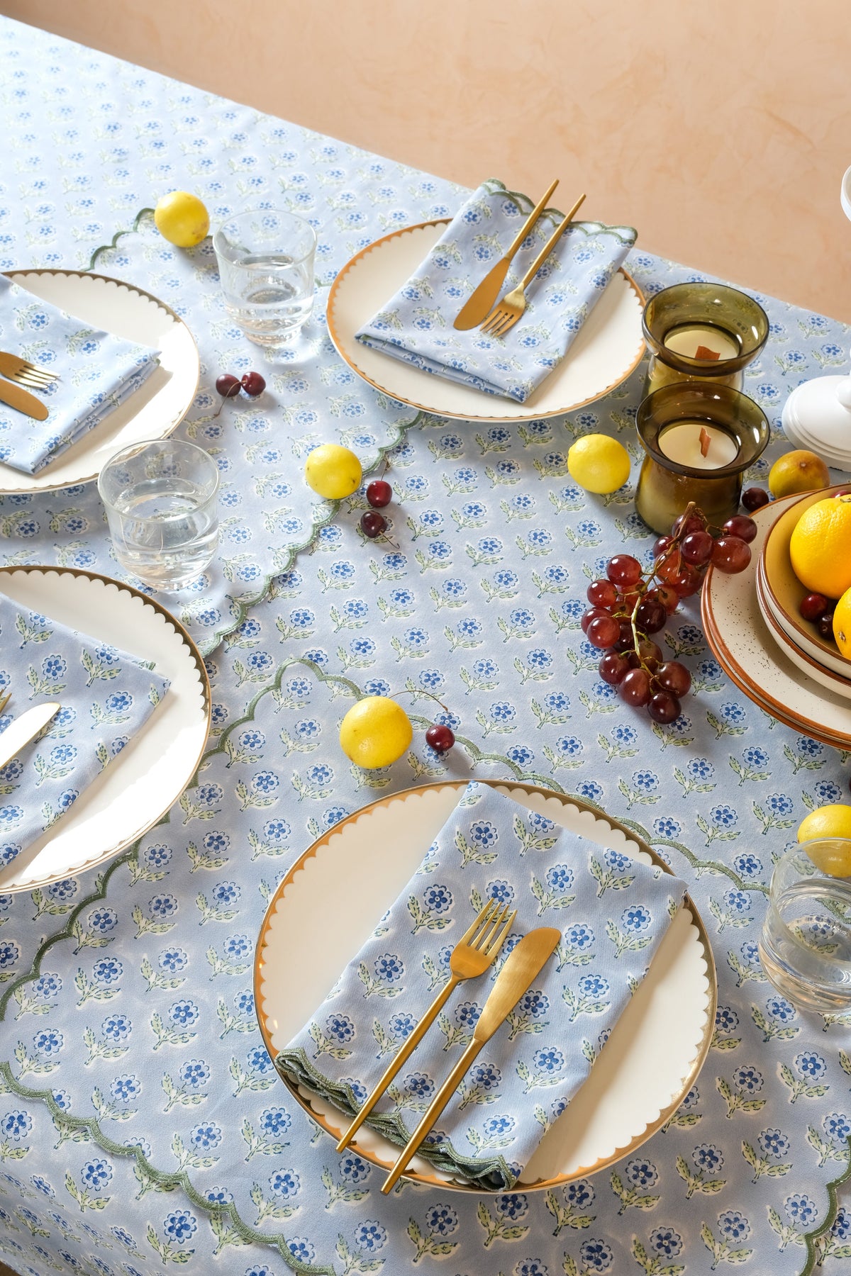 Blue floral table setting with scalloped placemats from Inner Child