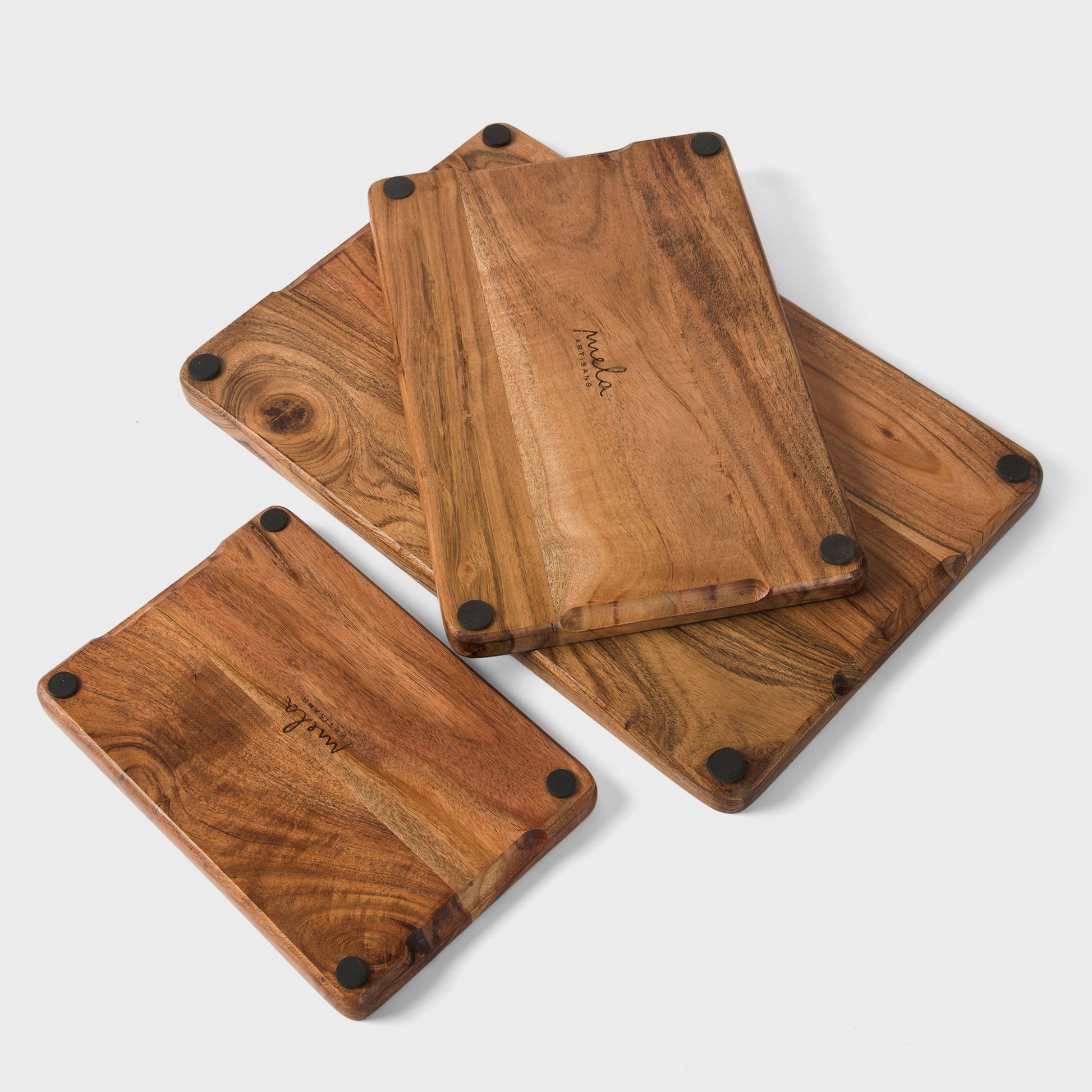 close-up of natural acacia wood grain on handcrafted cutting boards set
