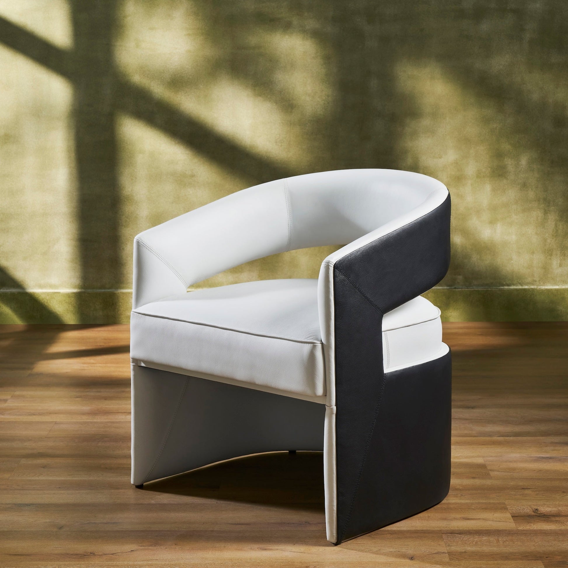 FN-5208-282429_2|Elegant contemporary leather furniture, a white and black accent chair with curved design, perfect for a chic living room.