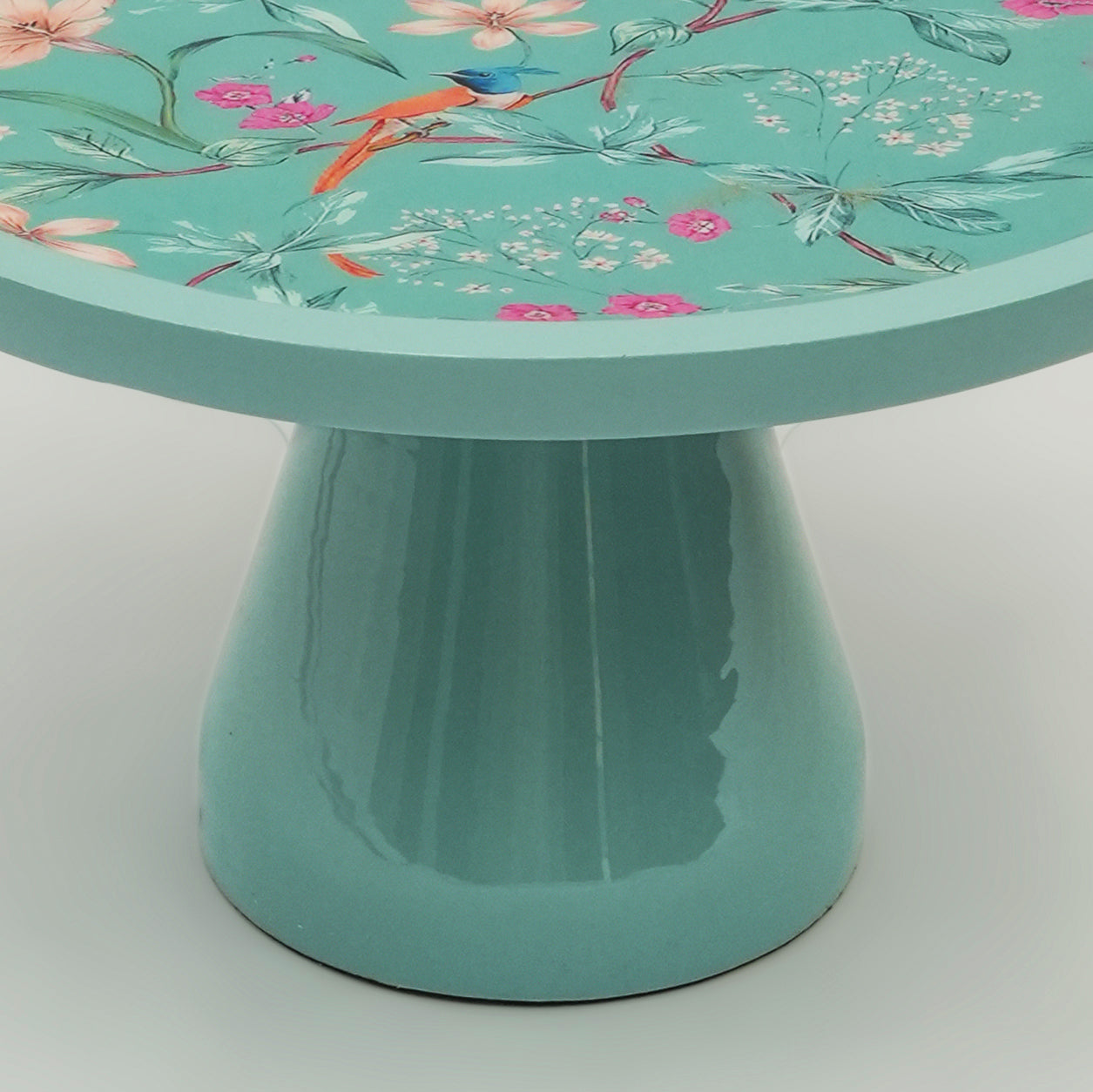 Aqua Flora pedestal stand used as a centerpiece with fruit bowls and desserts on a wooden table.