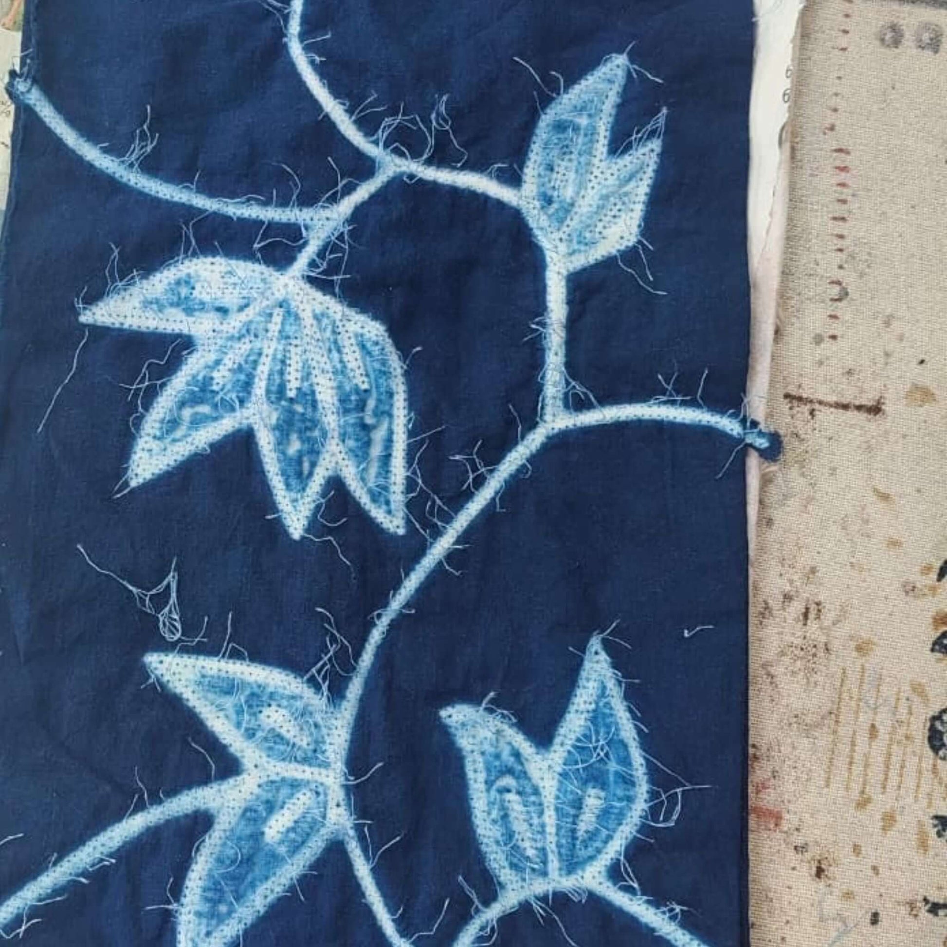 Folio Indigo Handcrafted Shibori Cotton Table Napkins ( set of 4 ) featuring intricate blue leaf patterns on dark indigo fabric.