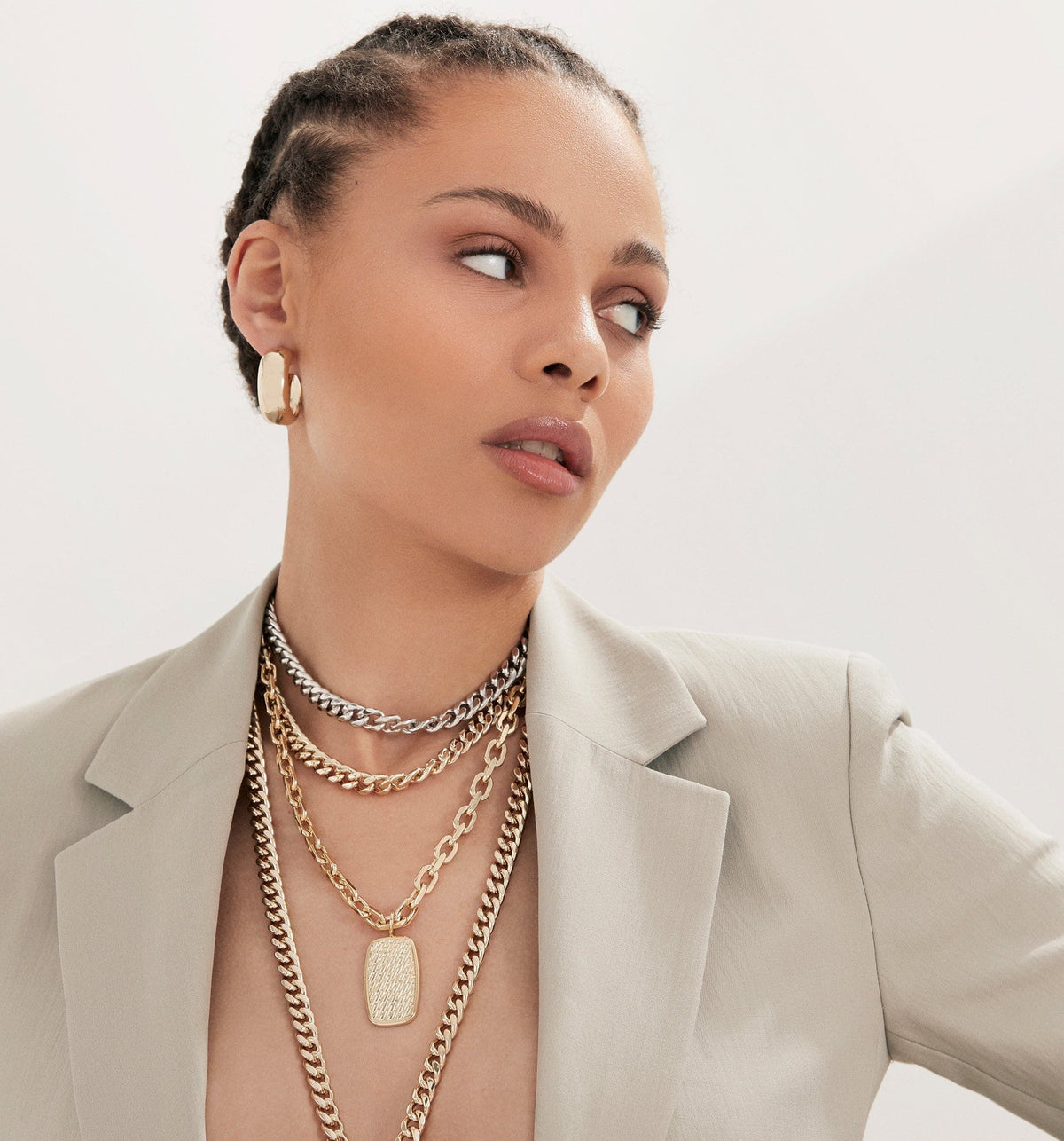 Woman wearing layered gold necklaces with the Curb Chain Lariat jewelry piece