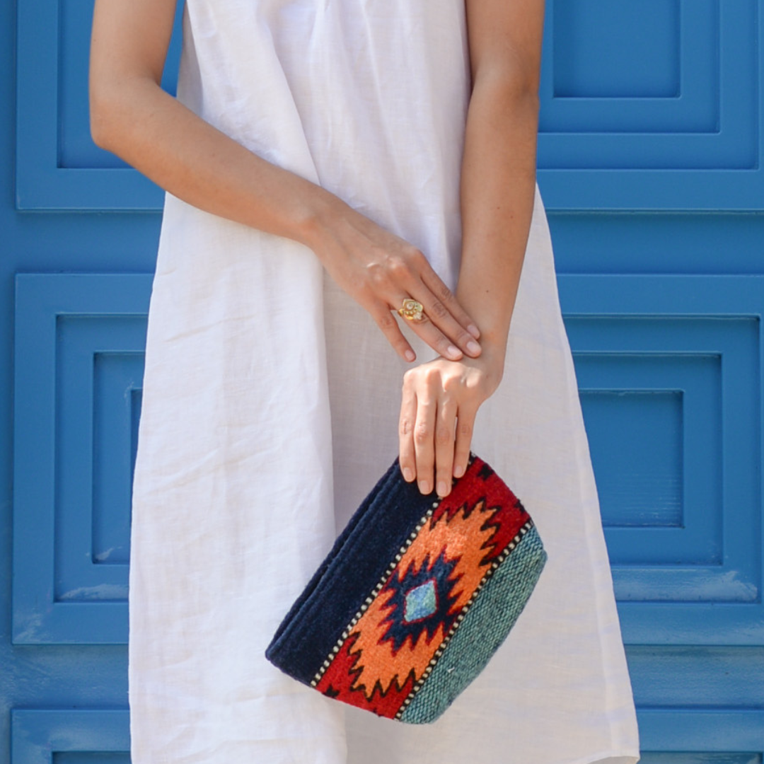 Handwoven pouch with abstract Zapotec arrow design in bold colors featuring internal pocket; perfect for makeup, wallet, or daily essentials.