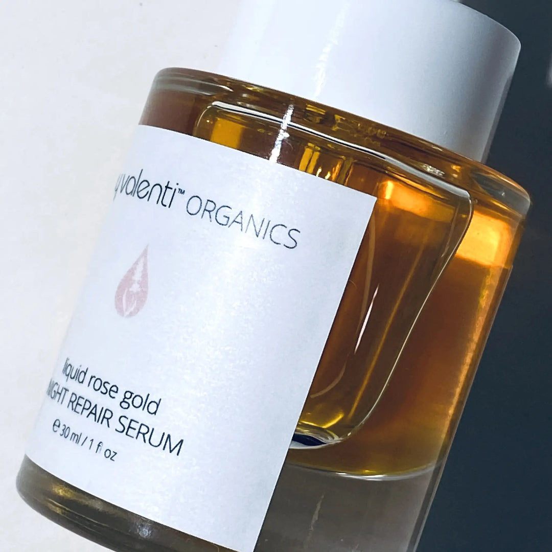 By Valenti closeup shot of glass bottle of Liquid Rose Gold Night Repair Cream