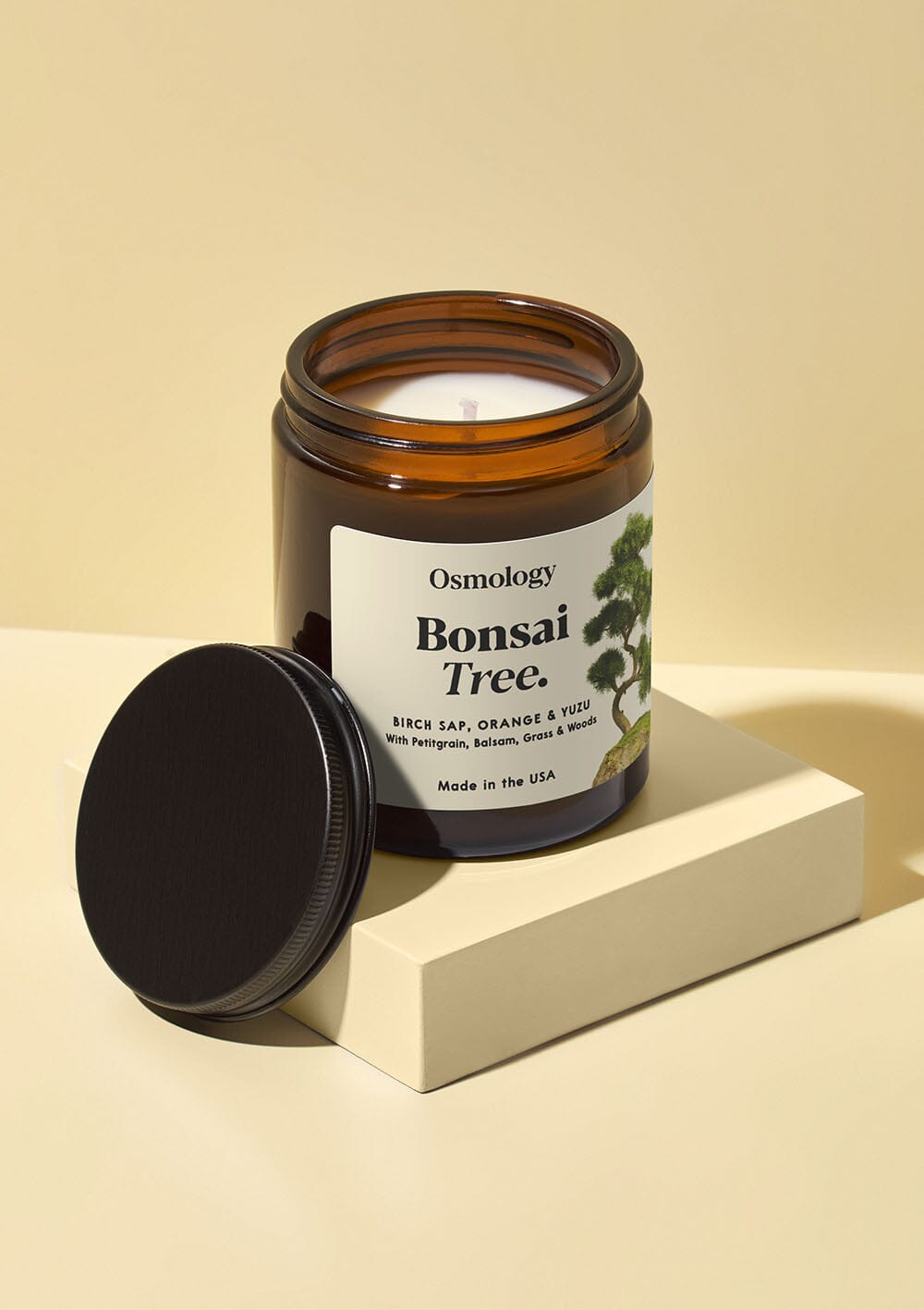 Osmology Bonsai Tree jar candle, brown glass jar with white label and black lid