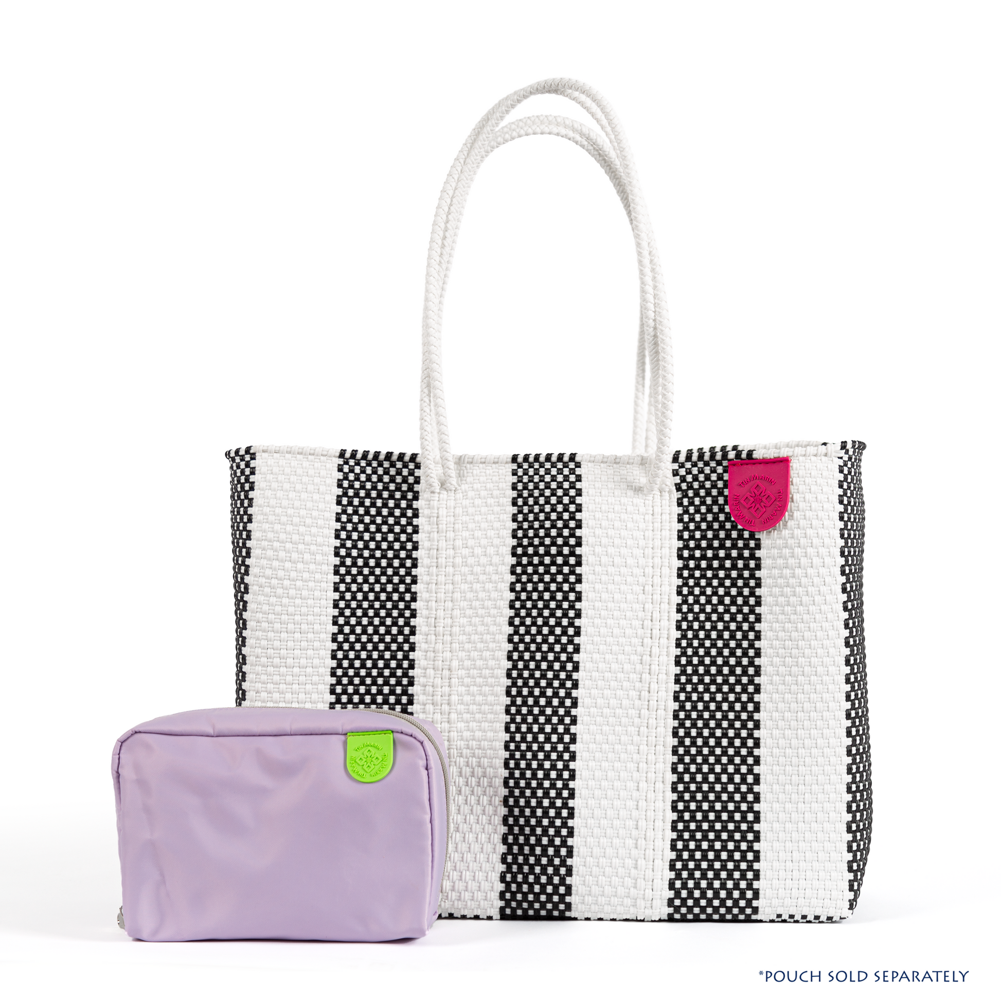 Tin Marin super tote in Zebra Design & checs nylon pouch in lavender, A black and white striped oversized tote bag with a purple pompom decoration, and a shoulder strap.