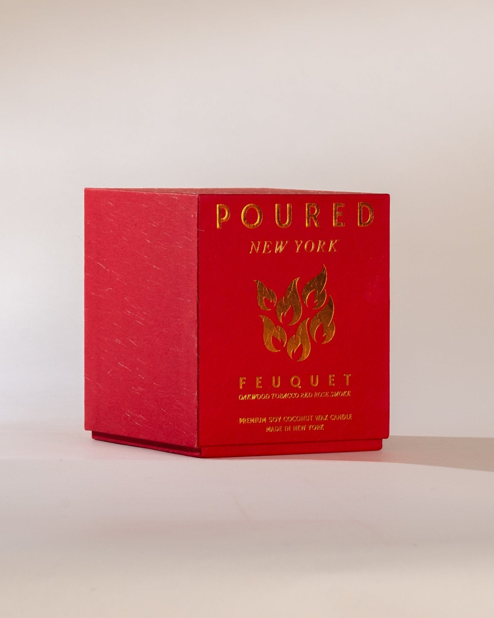 Poured New York ' Feuquet' red candle box with a flame decal on a neutral background
