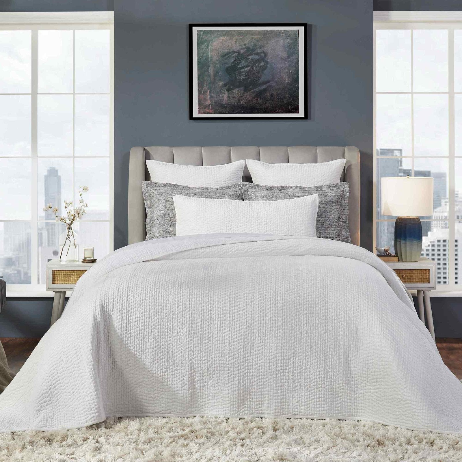 CL-182-9496-LOT1_1|Crisp white quilted coverlet with a subtle grid pattern on a stylish bed, perfect for modern bedroom aesthetics.