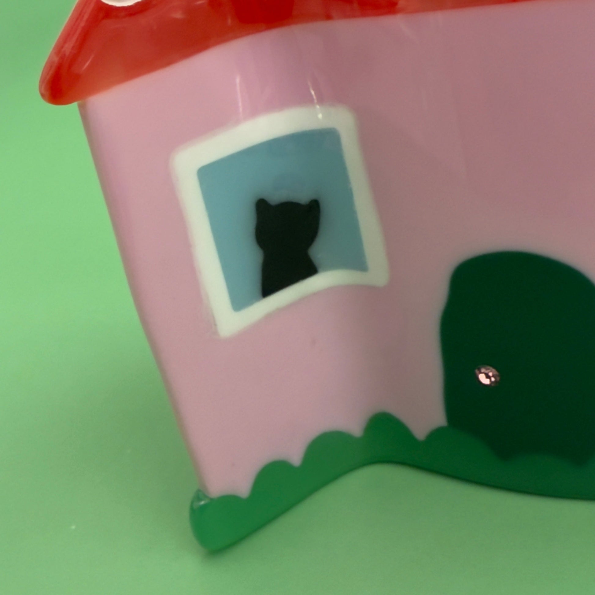 This charmin house hair claw, comes with an extra purr-k: a resident feline who will charmingly oversee the neighborhood from their sun-drenched window perch.

This practical yet cozy house hair claw, will hold strong as it's pink foundation. 

Who says you can afford a house! hehe, now you can! 
