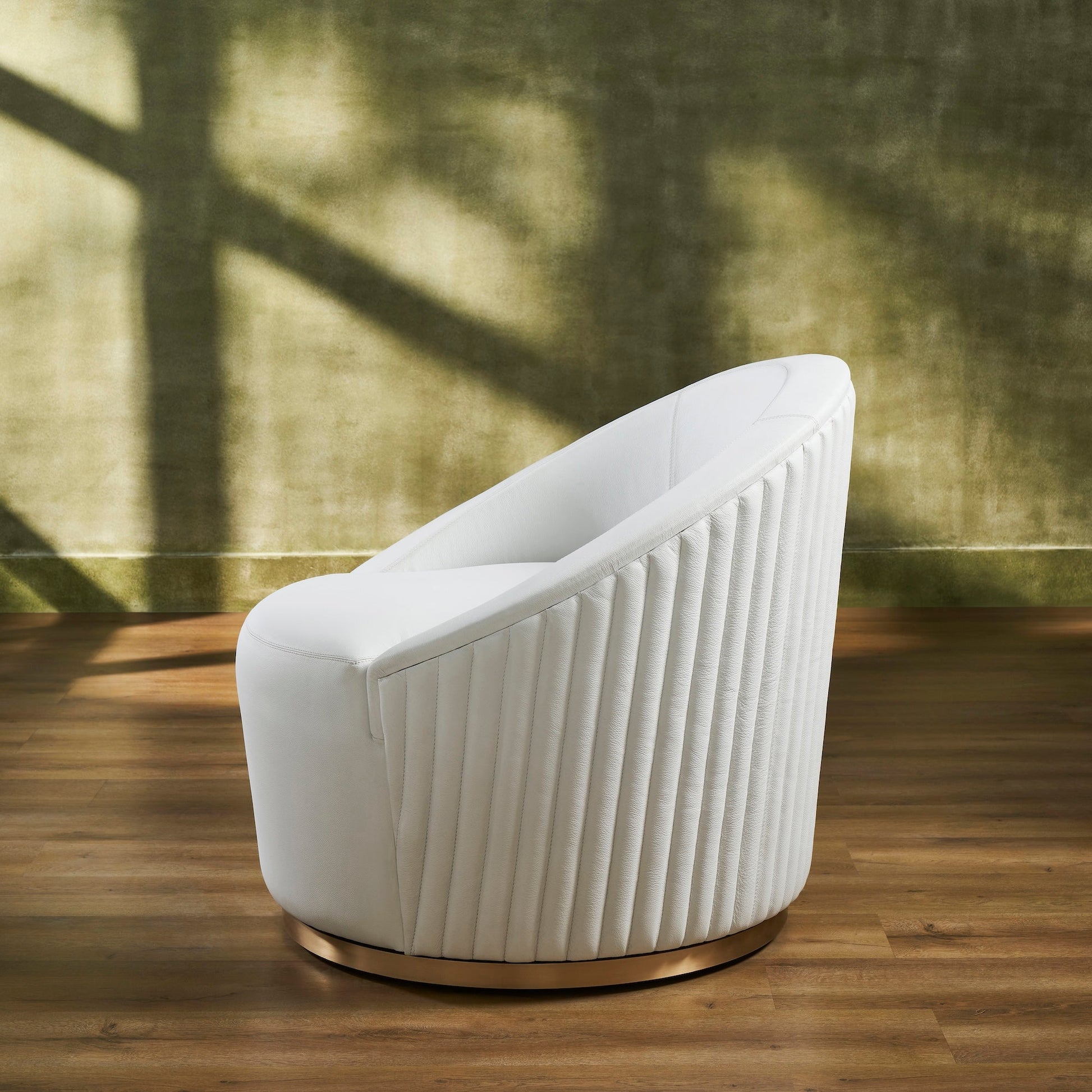 FN-5206-353529_4|Elegant white leather swivel armchair featuring sophisticated vertical ribbed detailing and a polished gold base, luxury lounge furniture.