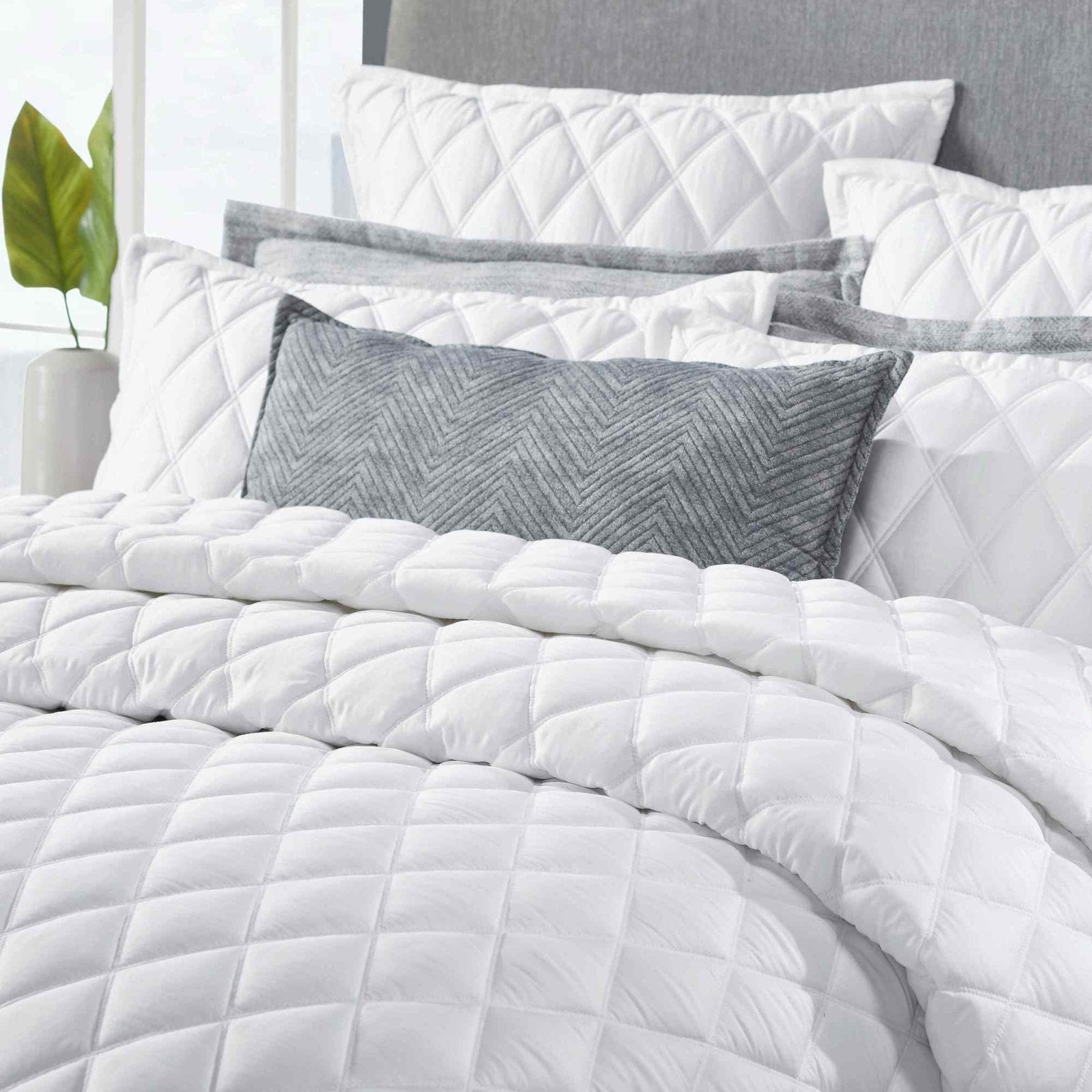 CL-179-11096_3|Detailed close-up of a white diamond quilted coverlet, showcasing its elegant pattern and soft, comfortable fabric.