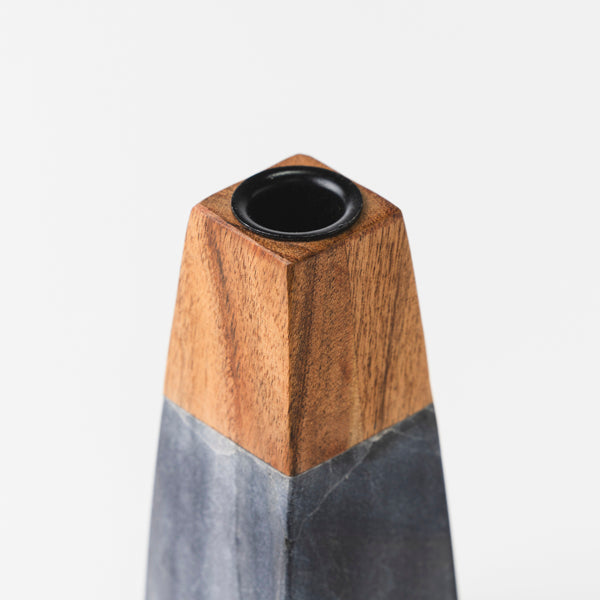 close-up of black marble and wood contrast on candleholder