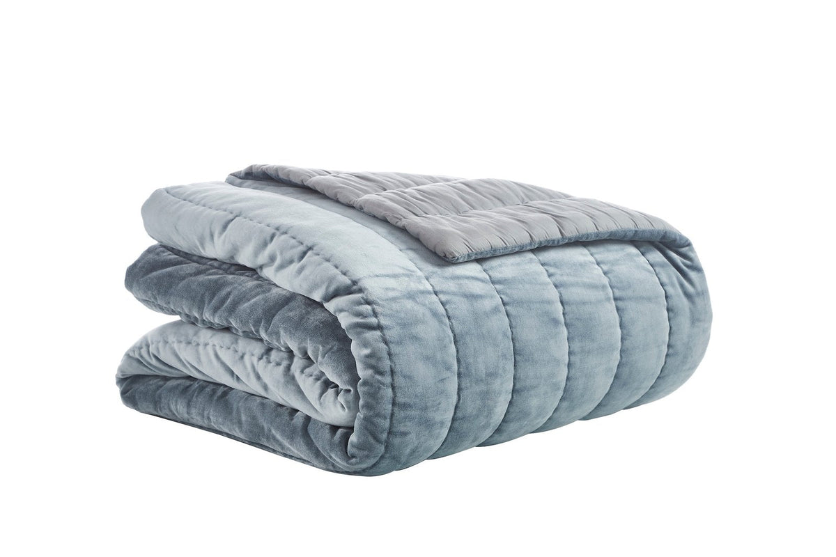 QT-360-9496_5|Folded soft grey-blue velvet quilt with channel stitching, highlighting its plush texture and modern elegant design perfect for any bed.