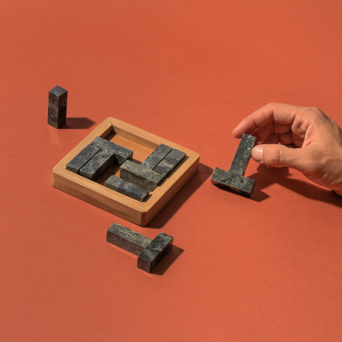 Handcrafted multi-stone Tetris puzzle acting as a striking architectural centerpiece in a modern living space.
