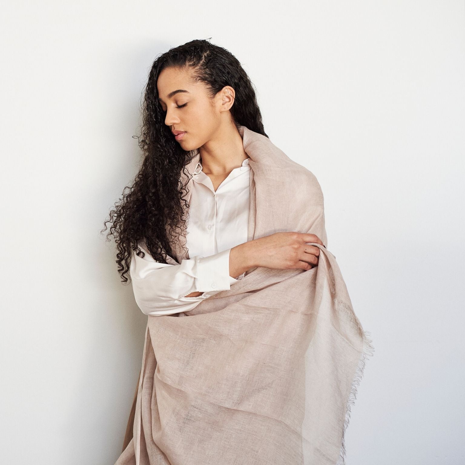 Oat Beige Neutral Hand Woven Soft Linen Silk Scarf elegantly draped over a woman in a white shirt.
