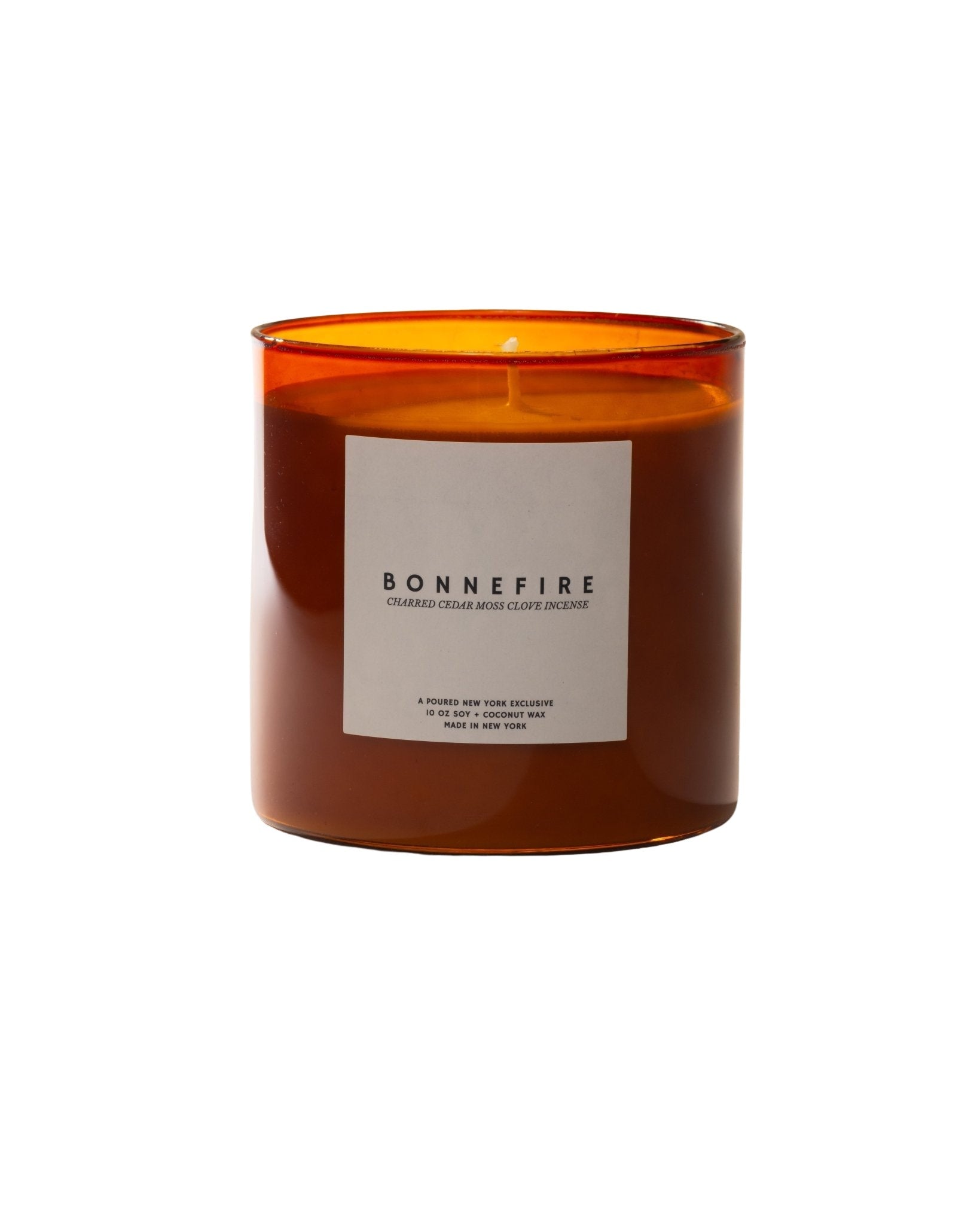 Bonnefire candle with an orange transparent container and a 'Poured' box in the background.