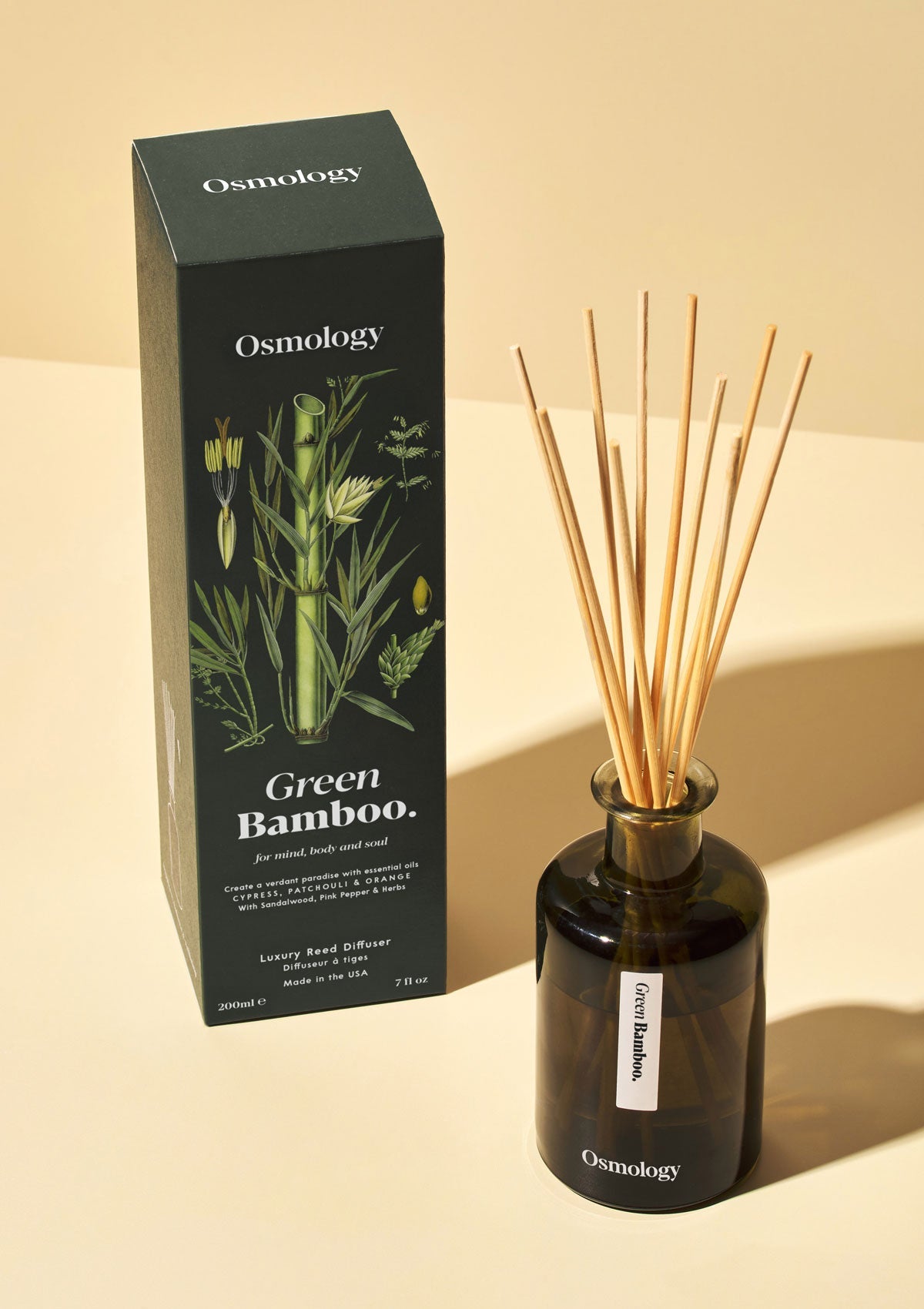 Osmology Green Bamboo reed diffuser with product packaging on white background