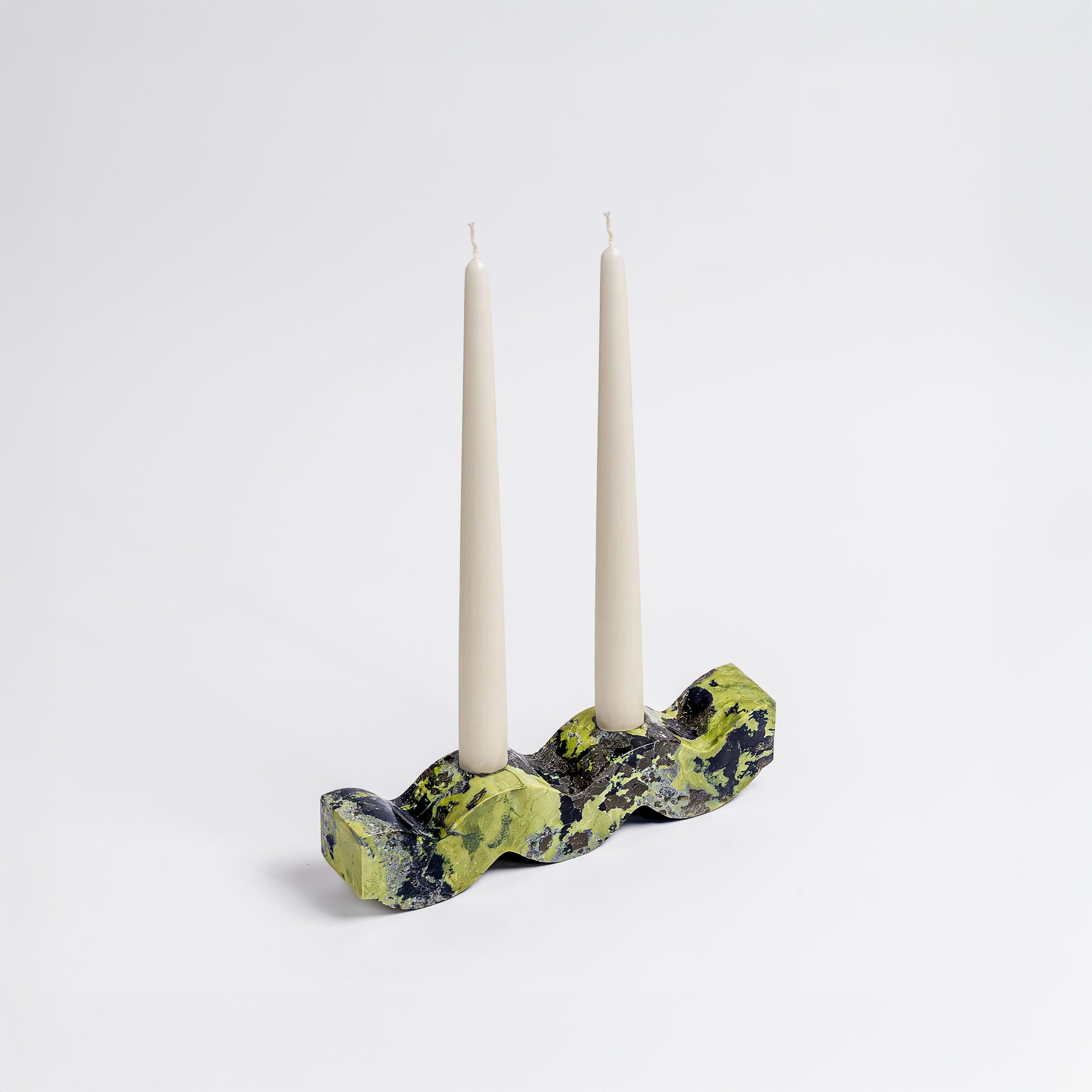 Wavy serpentine green gemstone candelabra displaying its rich natural tones on a white background.
