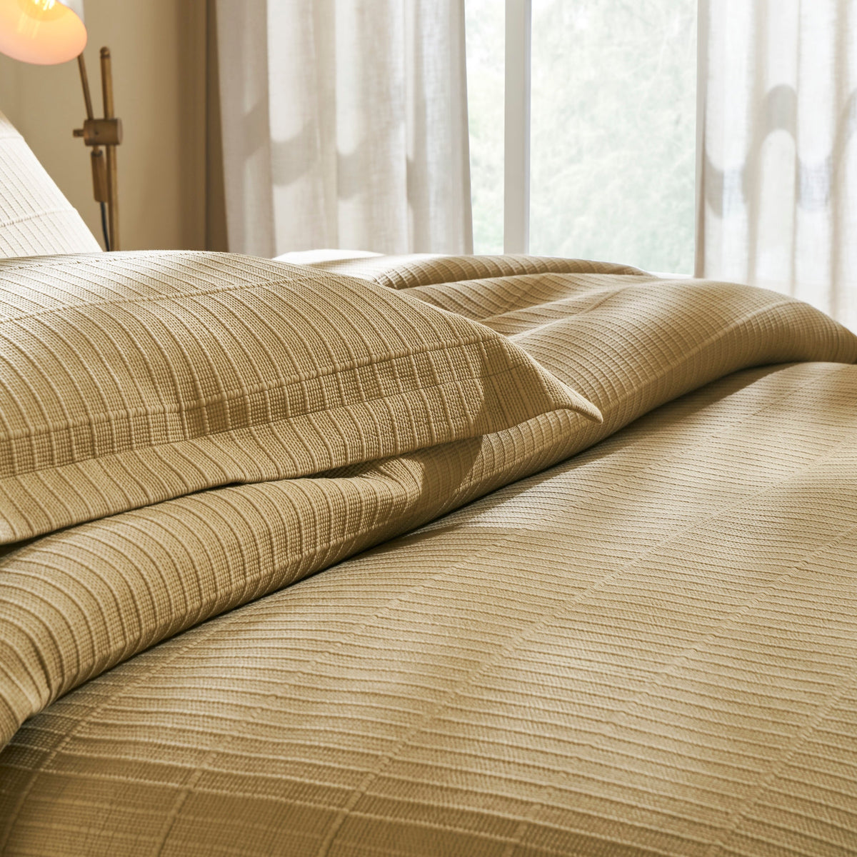 KS-269-2036_3|Stylish beige quilted coverlet and matching sham beautifully arranged on a bed, enhancing bedroom comfort and decor.