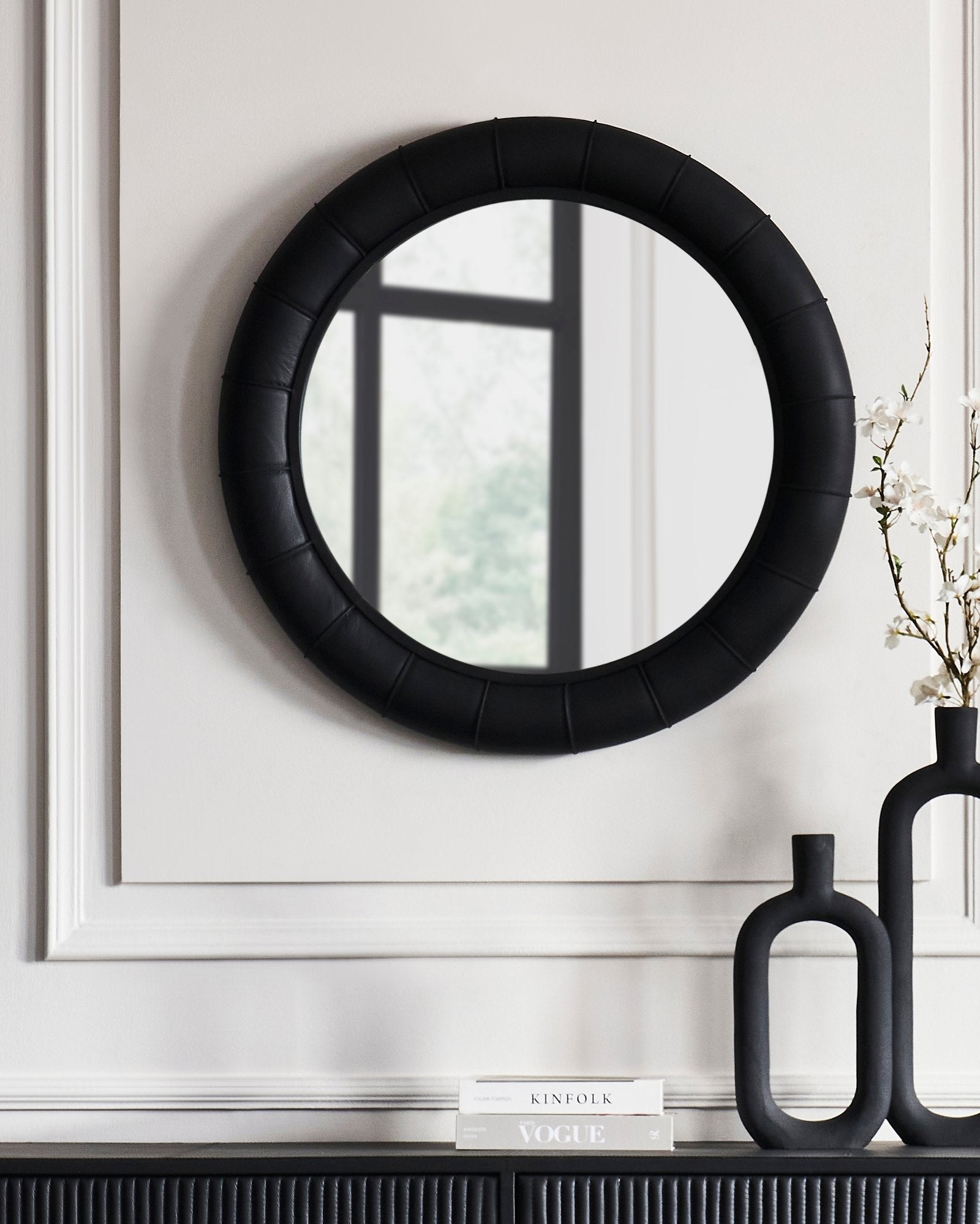FN-5202-33233_1|Elegant black leather-framed round mirror, padded channel-tufted frame, complementing luxurious leather console. Chic leather accent furniture.
