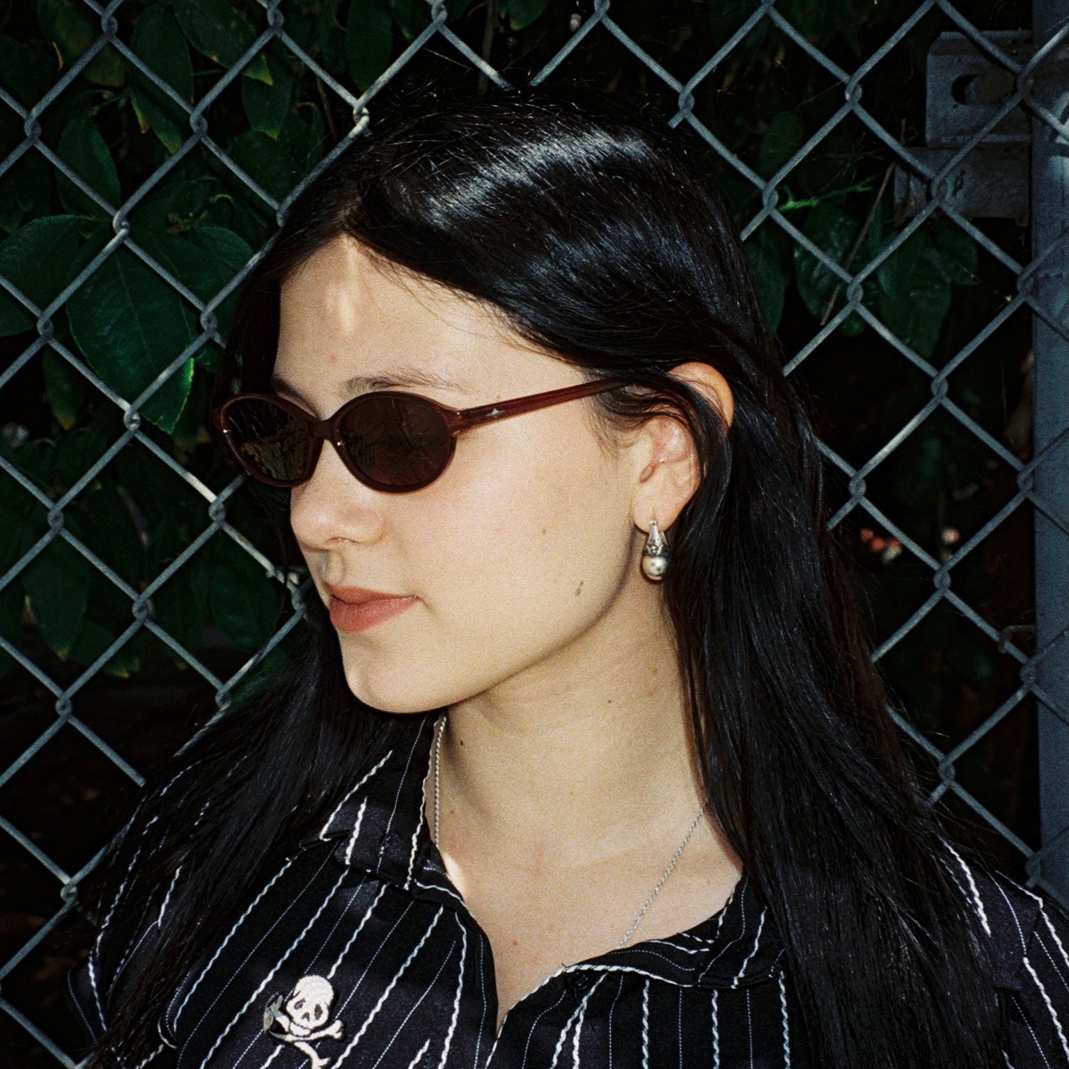 Macey Lemus wearing SAD Eyewear Celeste oval sunglasses in tobacco with polarized bronze UV protection lenses