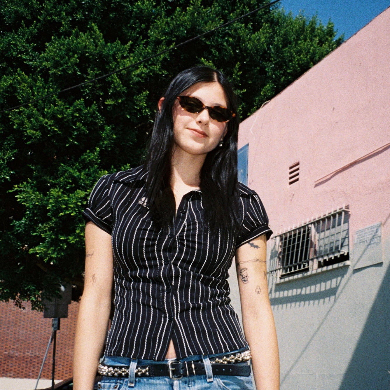 Macey Lemus wearing SAD Eyewear Celeste oval sunglasses in tortoise with polarized olive UV protection lenses