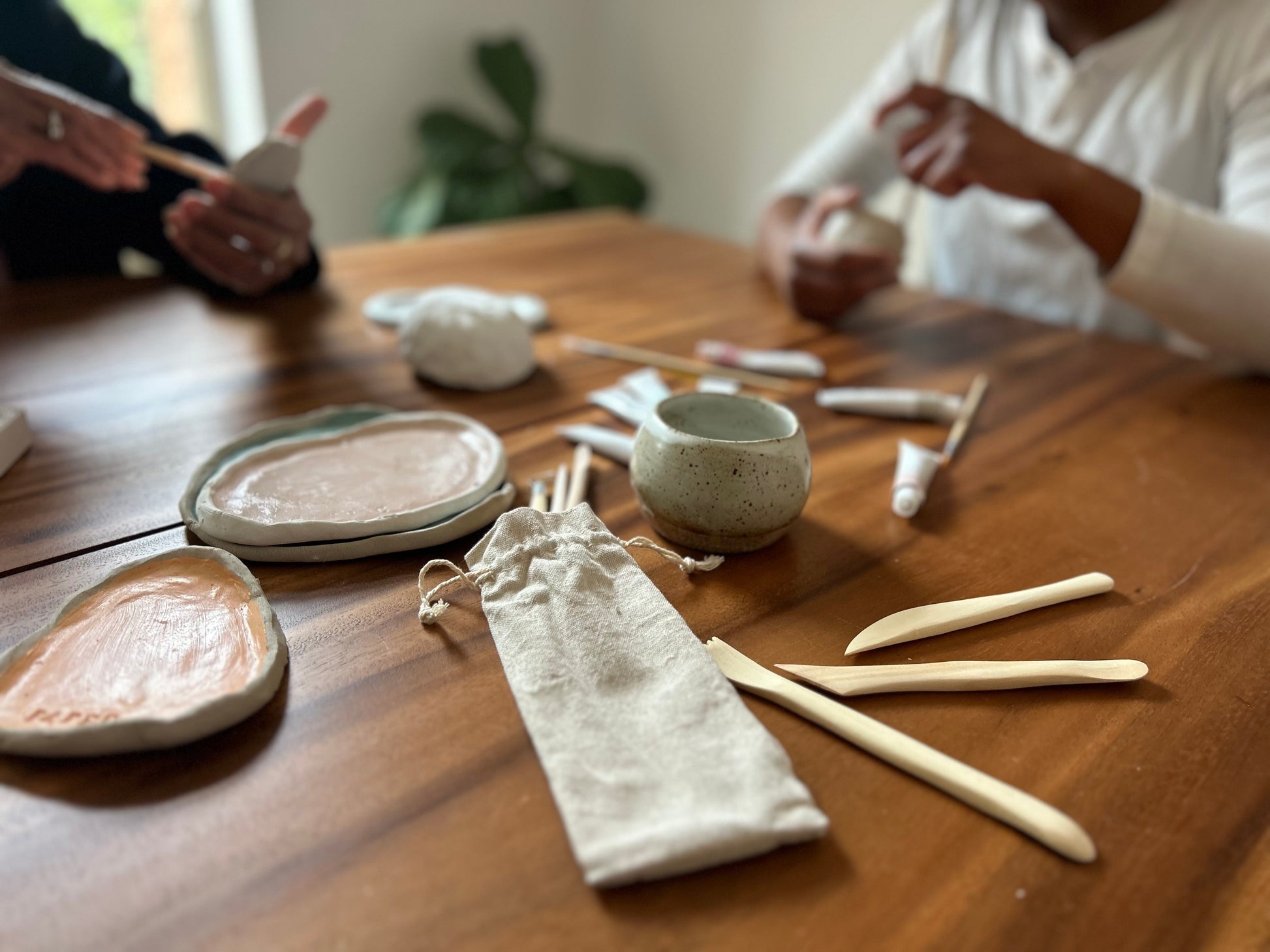 Clay date photo with tools and clay being used for creativity and connection. 