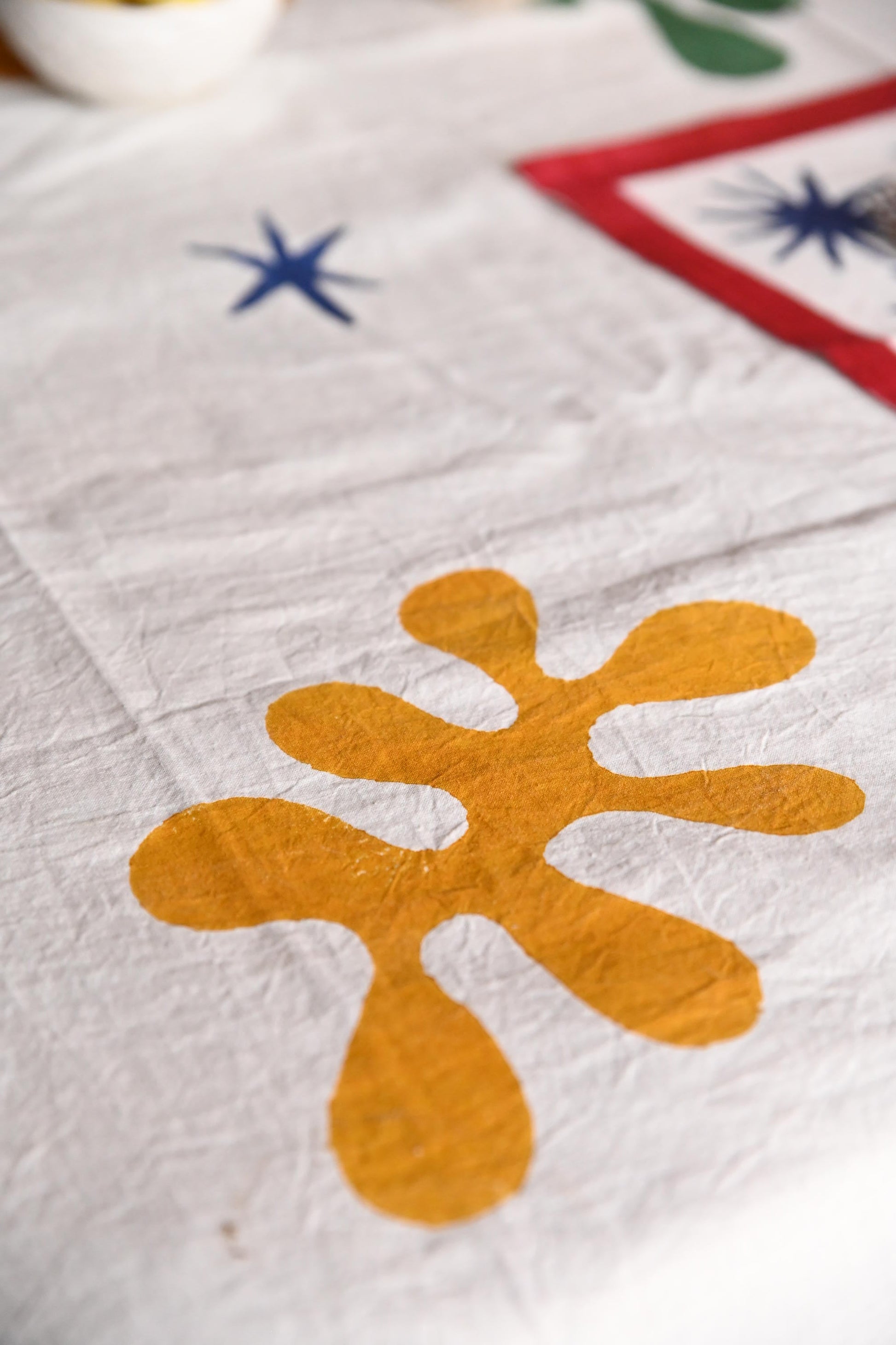 Celestial Matisse blockprint tablecloth close-up showing yellow shape detail