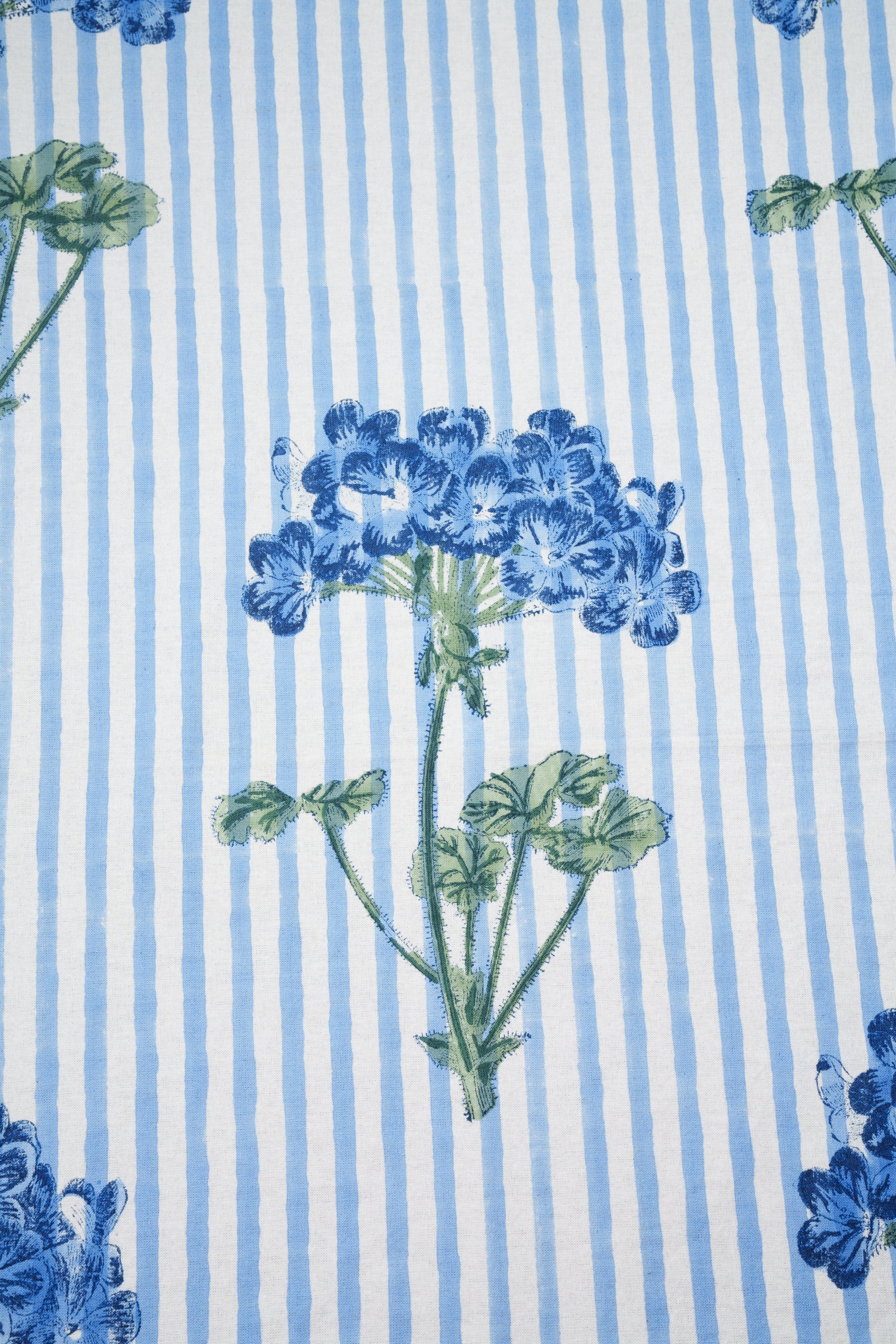 Inner Child blue hydrangea blockprint floral detail on striped fabric