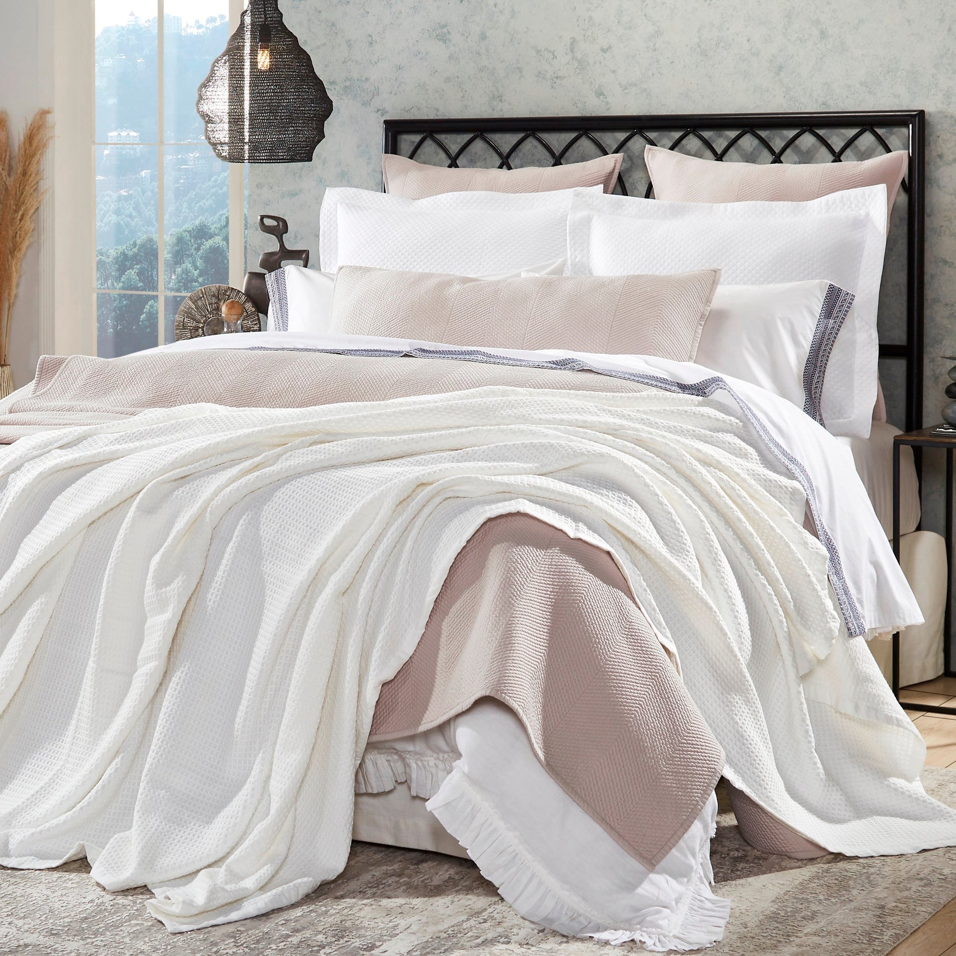 BL-856-11096_1|Elegant white waffle weave blanket layered with a cozy light pink throw on a stylish bed, perfect for a modern bedroom.
