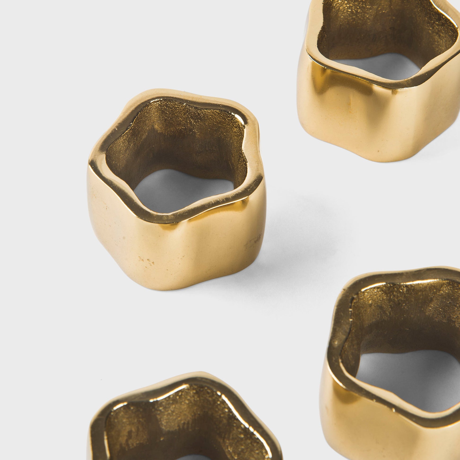 Mela Artisans Set of 4 Gold Toned Sculpted Napkin Rings for formal dining and holiday table decor.