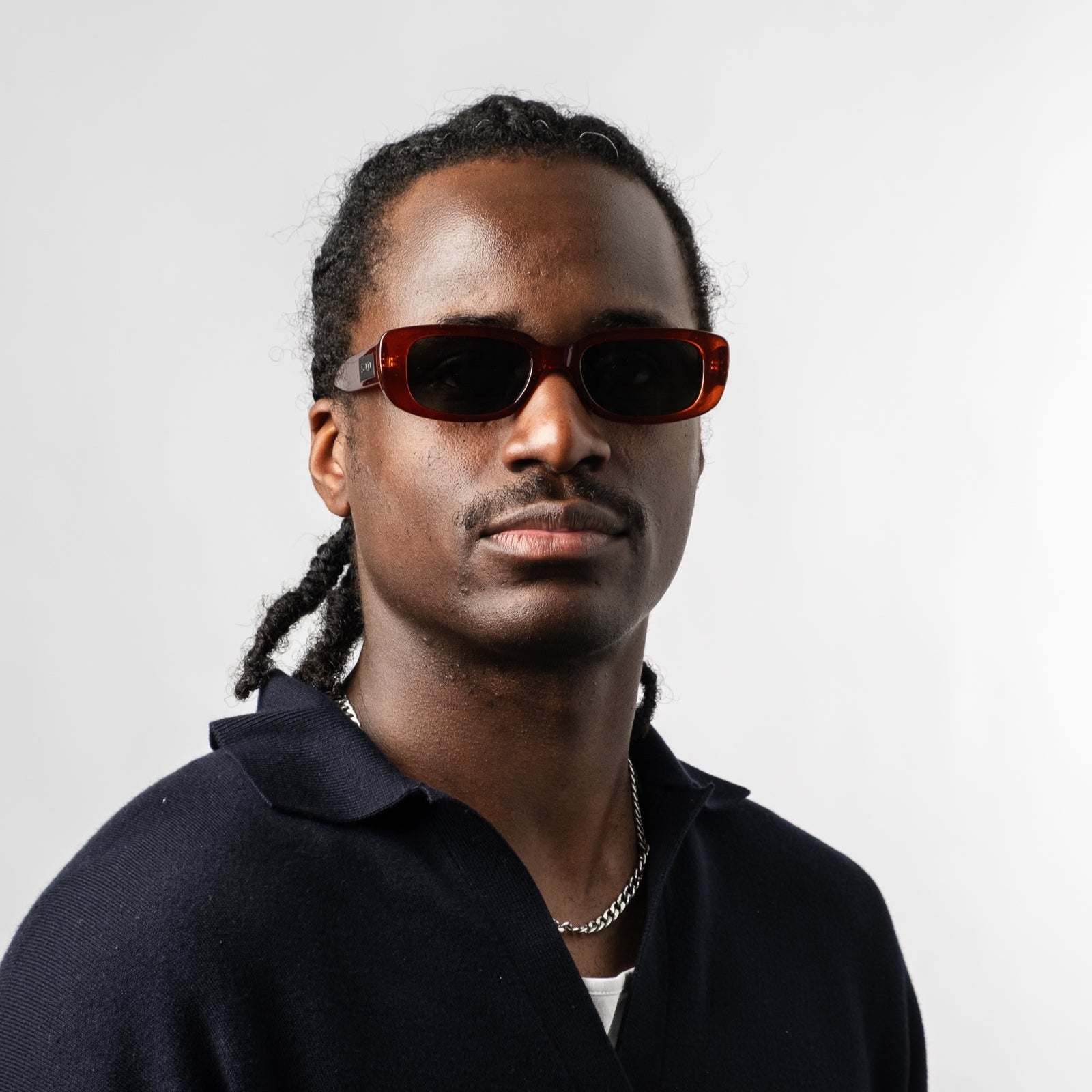 Male wearing Sad Eyewear Bouquet rectangle sunglasses in blood red with black tinted lenses