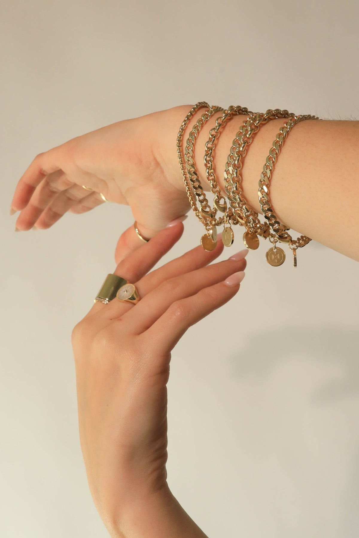 Gold chain bracelets with coin charms for the Micro Royal Rolo Chain Bracelet style