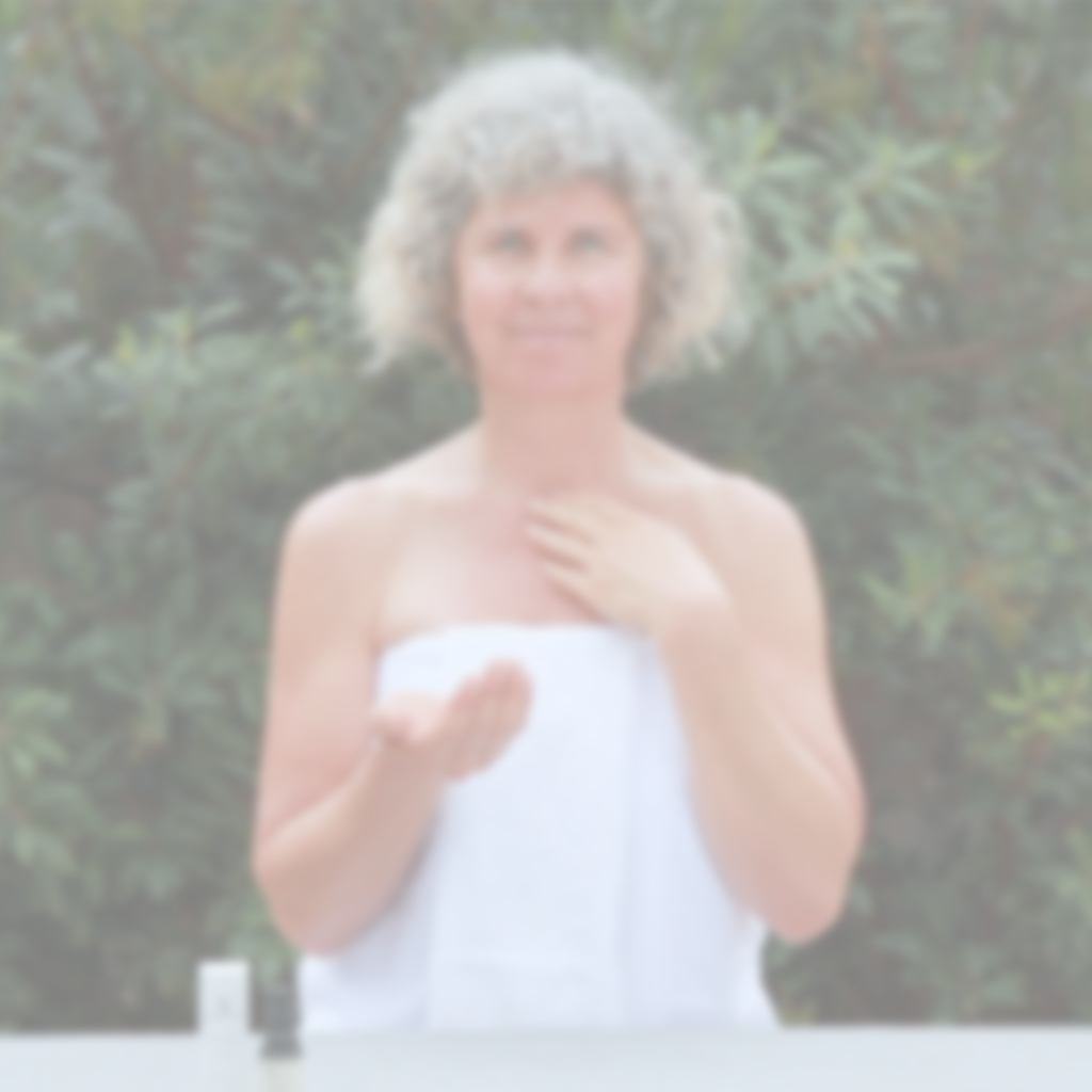 Video of woman demonstrating facial oil application using Annmarie Skin Care Anti-Aging Facial Oil in an outdoor setting.
