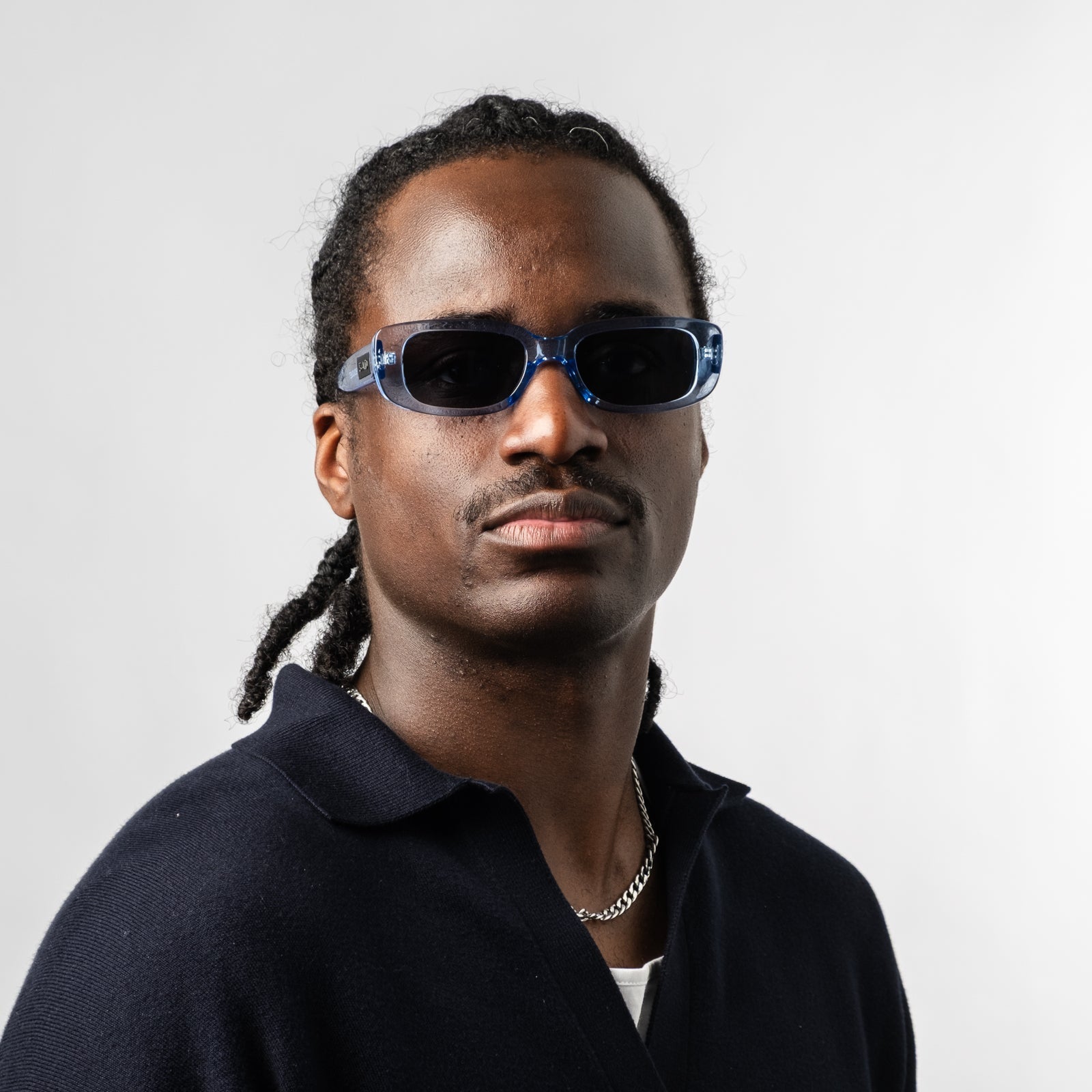 Male wearing Sad Eyewear Bouquet rectangle sunglasses in arctic blue with black tinted lenses