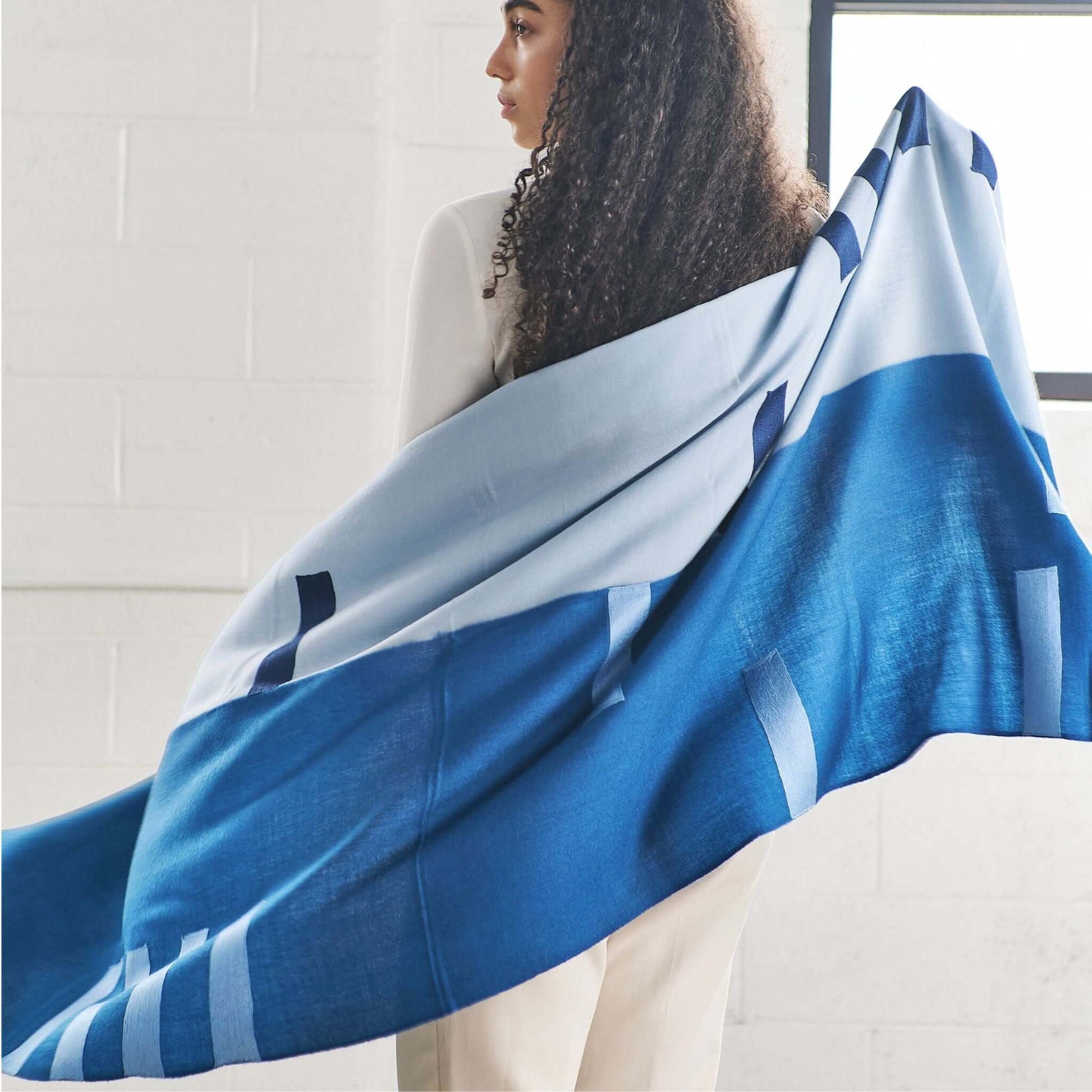 Harbor Blue Silk Merino Hand Woven Hand Embroidered Modern Artisanal Scarf draped over a model showcasing its beautiful design.