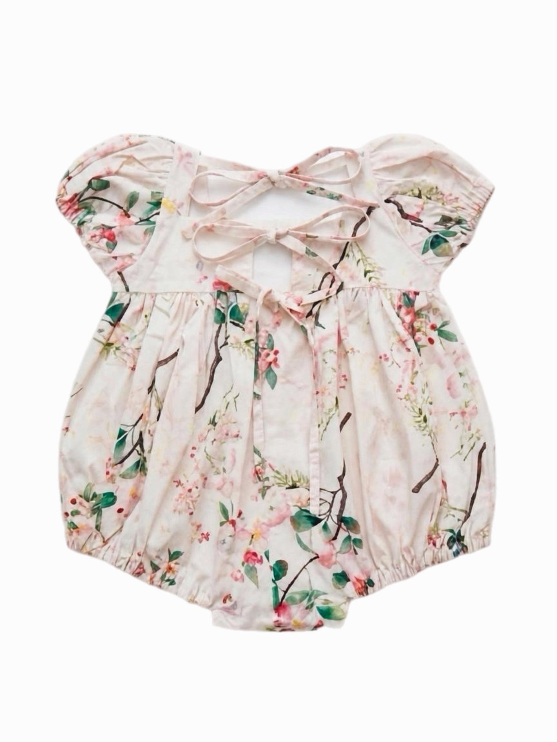 Floral baby romper with bow detail on a white background