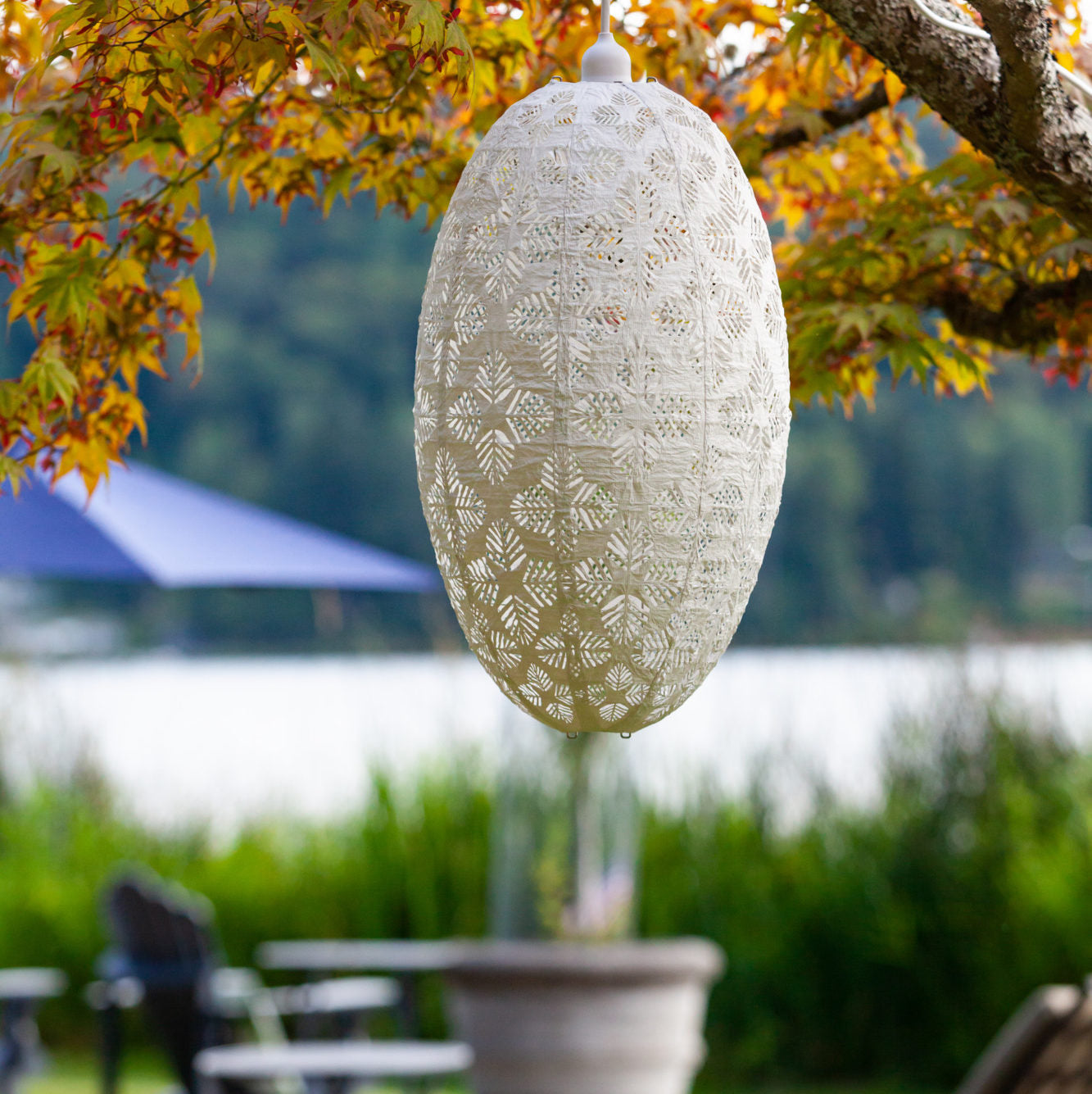 Soji Stella Nova Palm Pod Indoor Outdoor Tyvek Pendant Lamp in tree